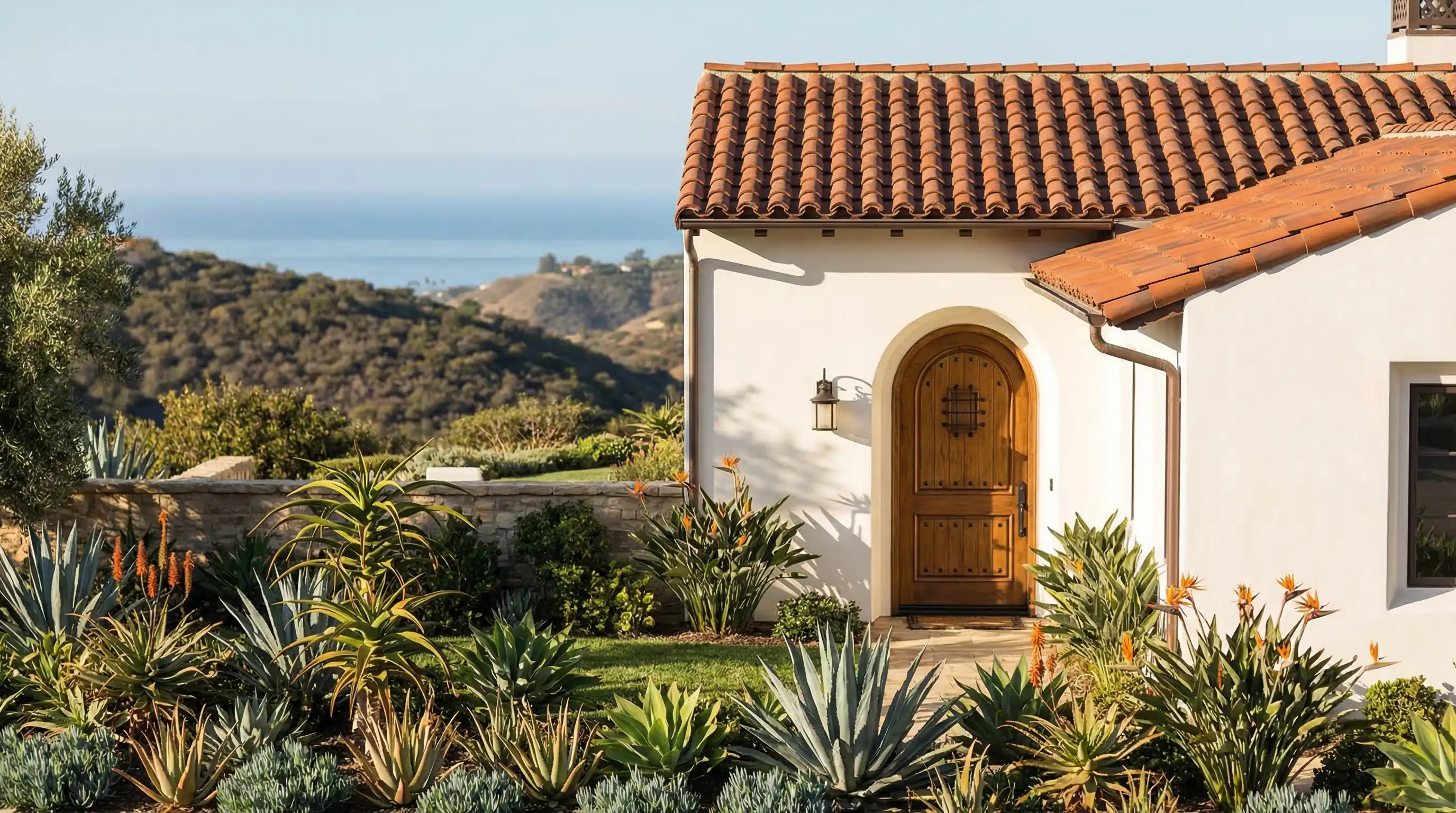 Real estate agent showing a modern Spanish-style San Diego home to buyers in bright California sunlight
