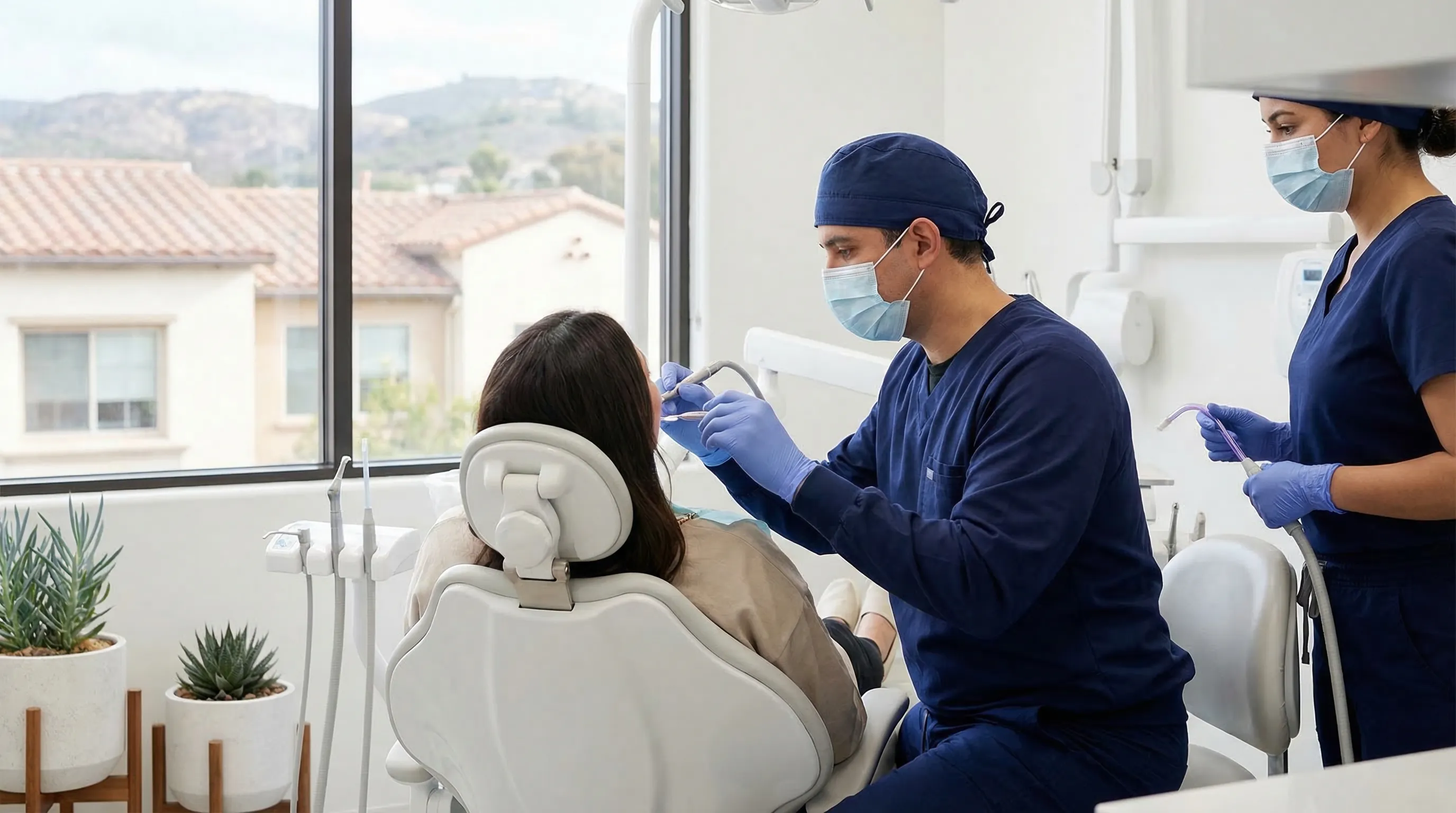 Modern dental office interior in San Diego CA with bright operatory and professional dentist treating patient