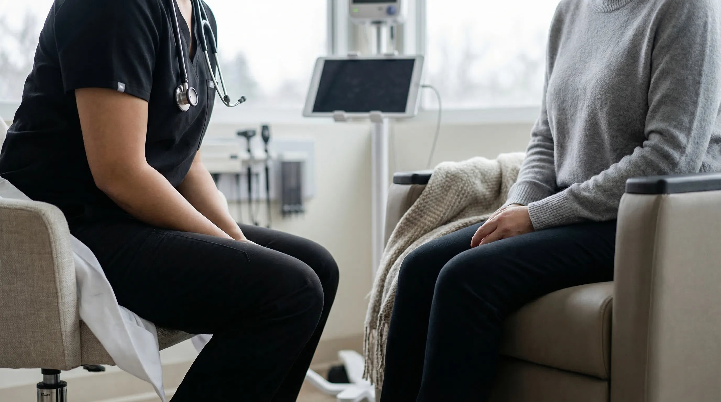 Independent medical practice physician consulting with a patient in a modern exam room in Detroit, MI, with professional attire and natural window light