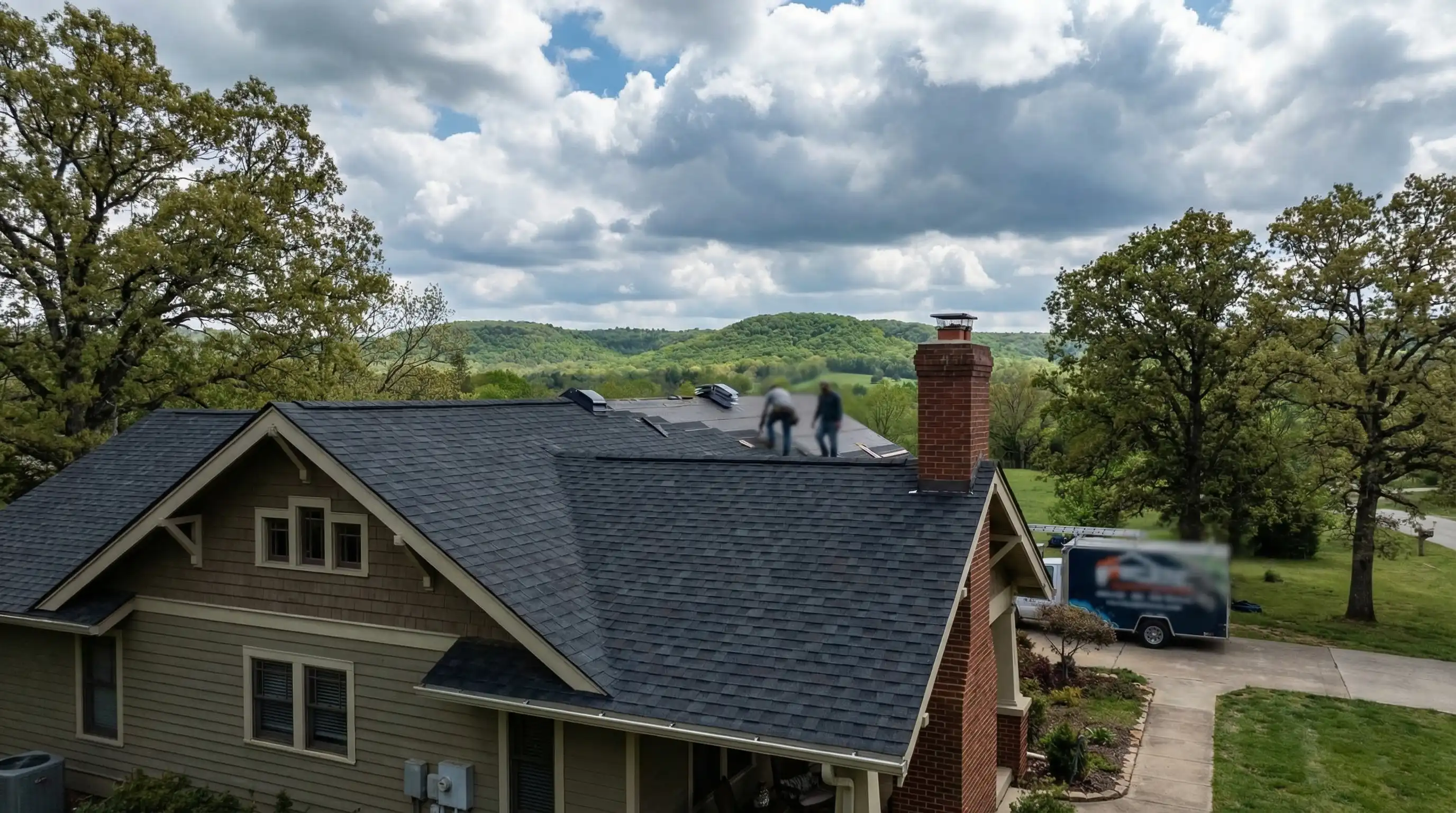 Licensed roofing contractor installing architectural shingles on a Fayetteville, AR craftsman home with Ozark hills visible in the background
