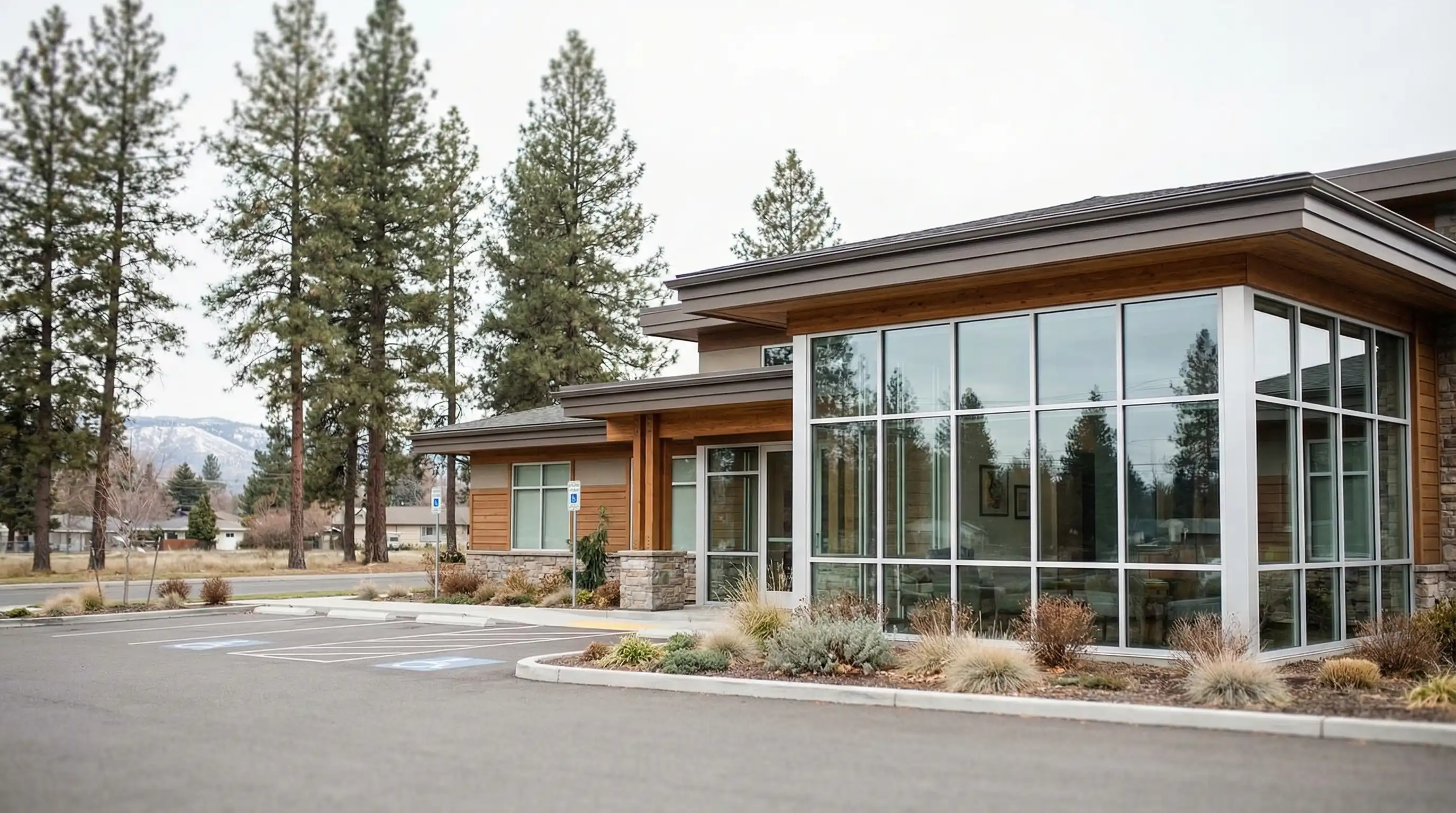 Modern dental operatory at a locally owned Spokane dental practice, with a dental chair, overhead light, and Washington state dental credentials on the wall, and a glimpse of a residential Spokane neighborhood through the window