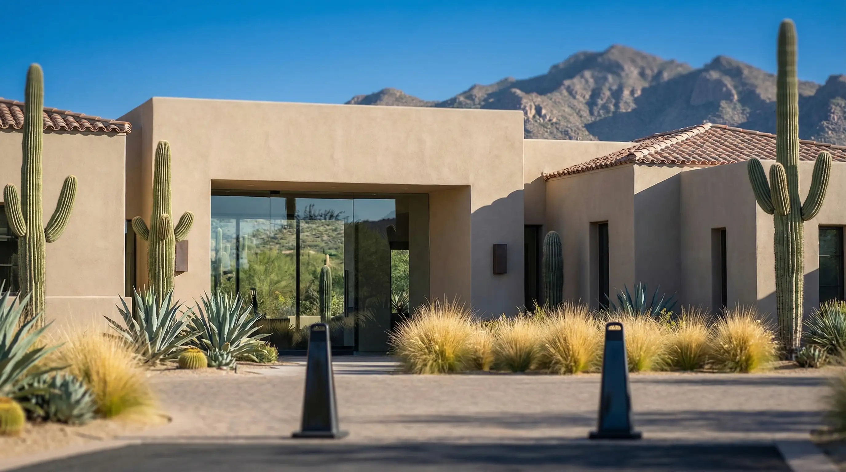 Interior treatment room of a high-end Scottsdale medspa with soft lighting, white and sand tones, and a nurse practitioner reviewing treatment notes with a patient in a reclined chair