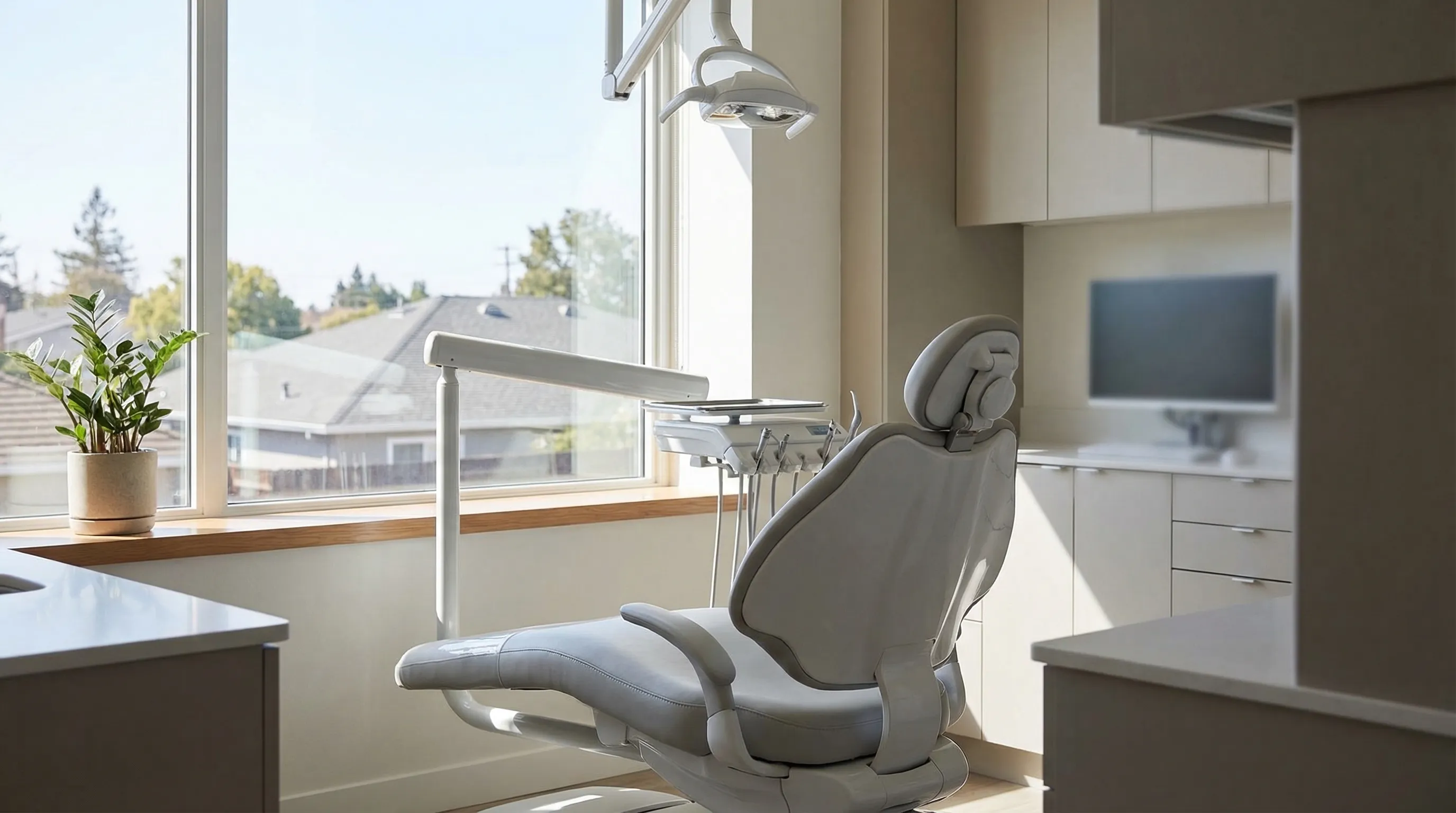 Modern dental office interior in San Jose, CA with dentist and patient during consultation in bright professional treatment room