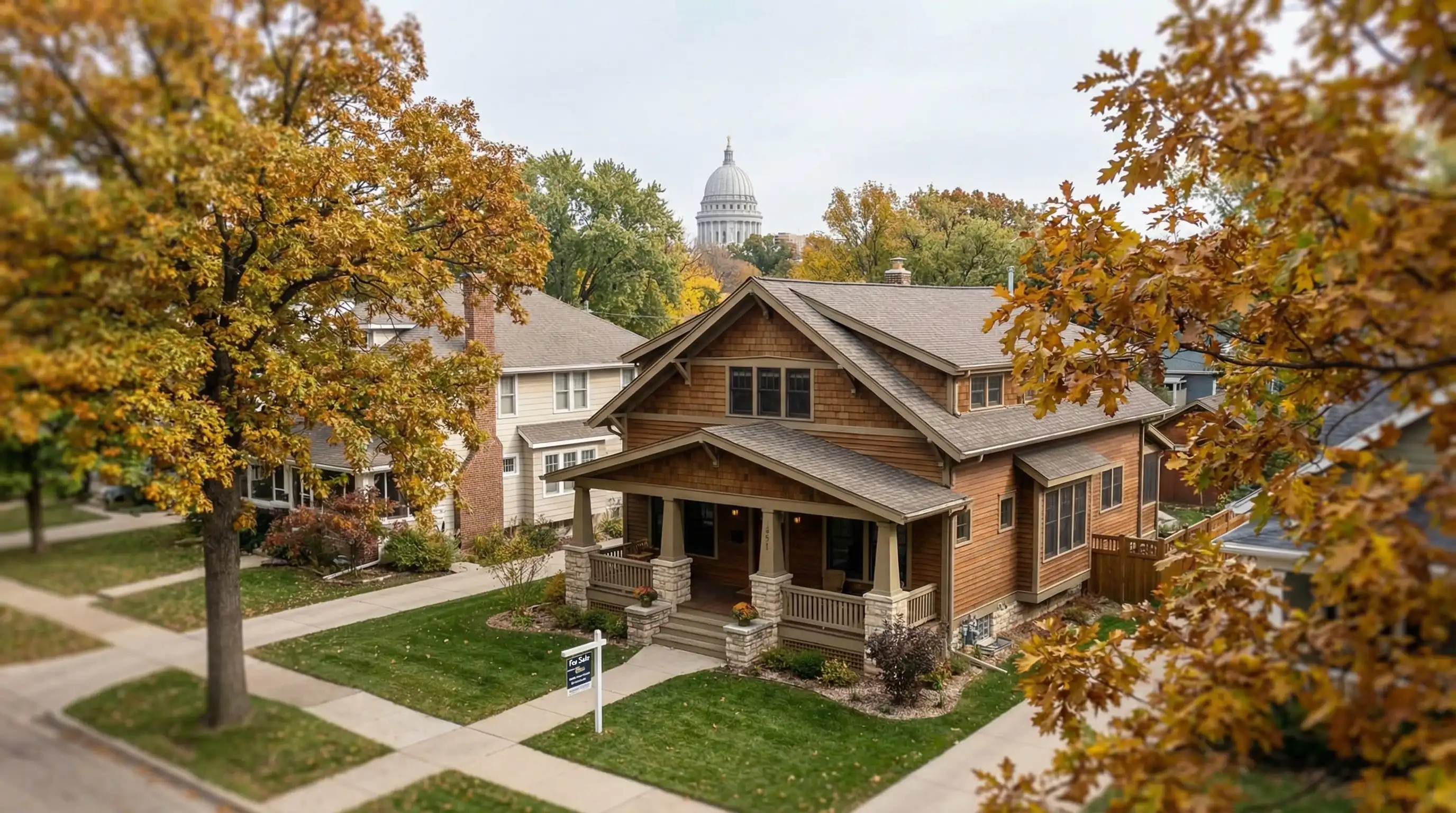 Professional real estate agent meeting with client couple at a modern conference table in Madison, WI office with city view
