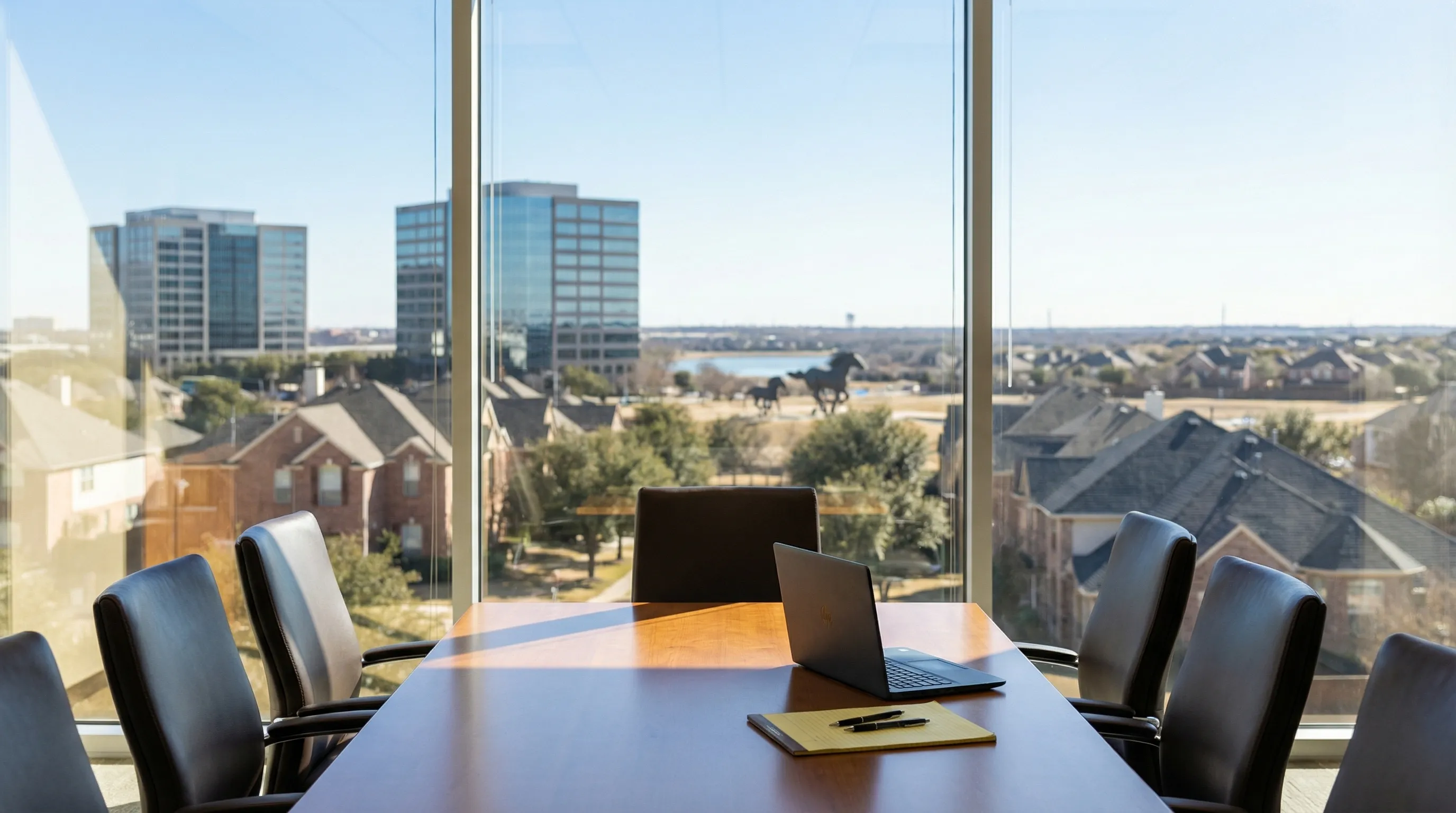 Modern law office conference room in Irving, TX with Las Colinas skyline visible through floor-to-ceiling windows