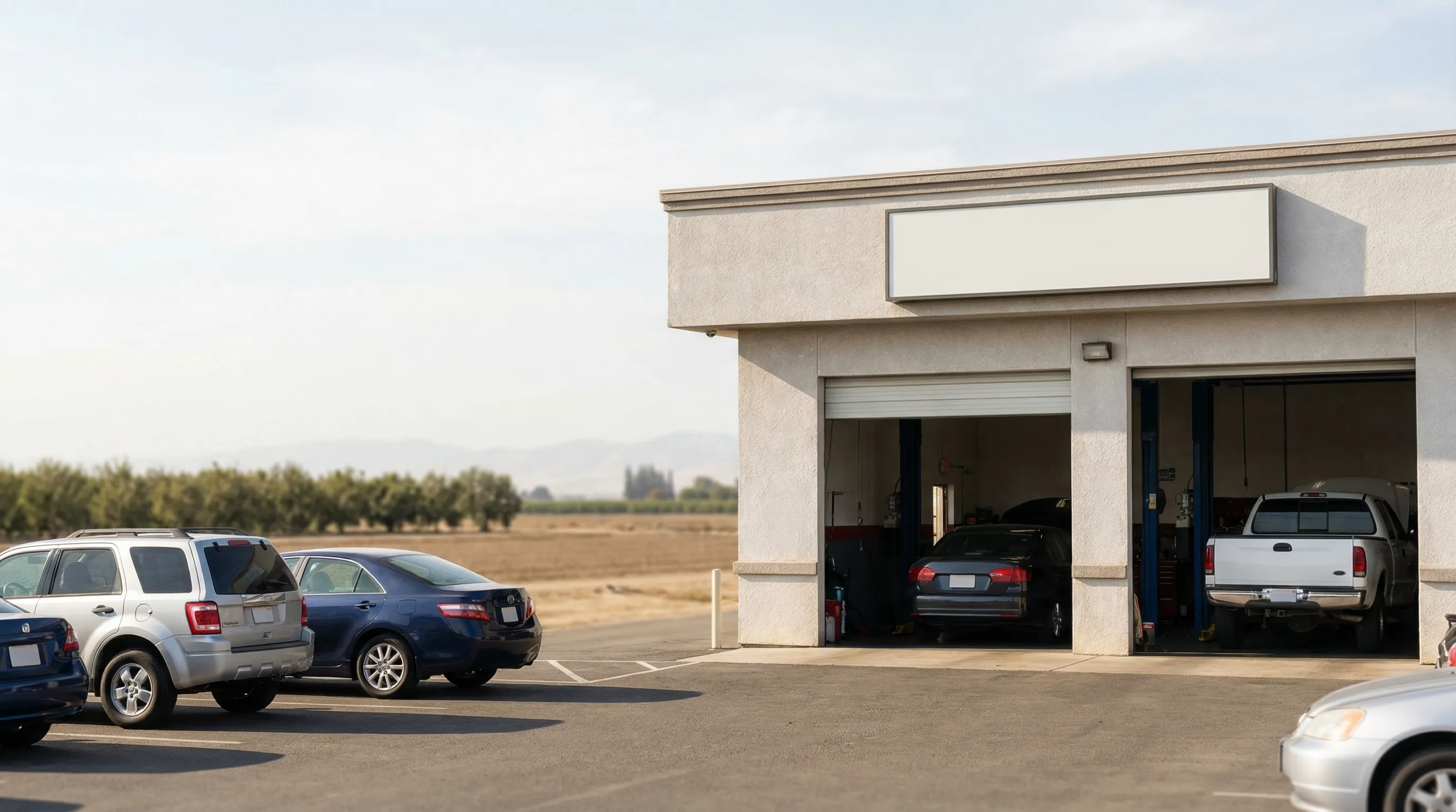 Independent auto mechanic performing brake inspection on lifted vehicle in a clean Modesto, CA repair shop