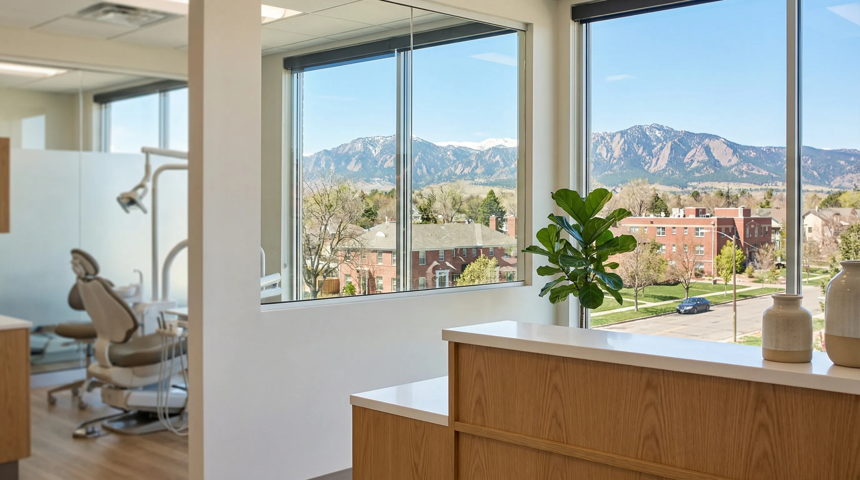 Modern Fort Collins dental practice reception area with Rocky Mountain foothills visible through large windows, conveying local expertise and patient comfort
