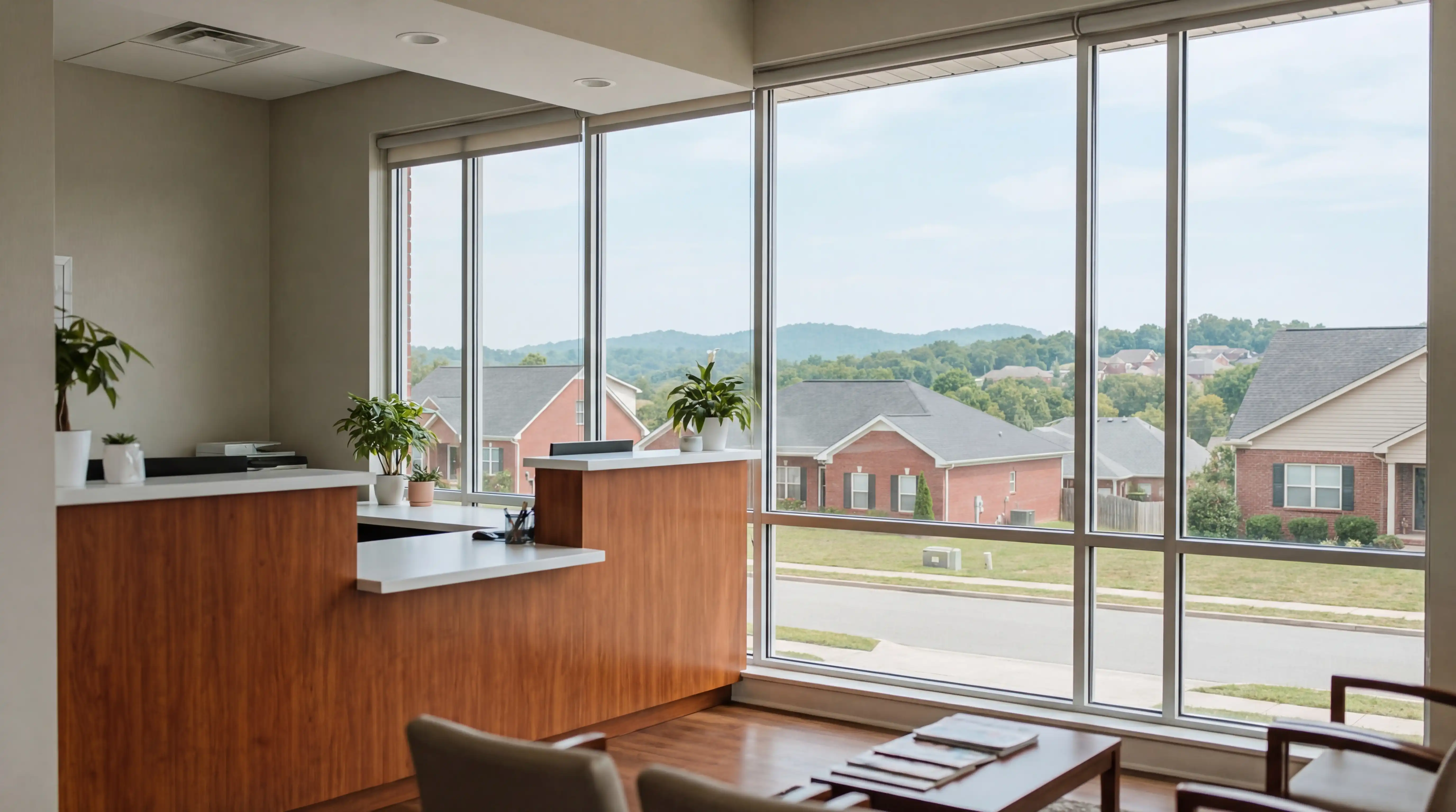 Modern dental practice consultation room in West Knoxville, Tennessee with natural light and Tennessee hills visible through window, professional dentist reviewing treatment plan with patient