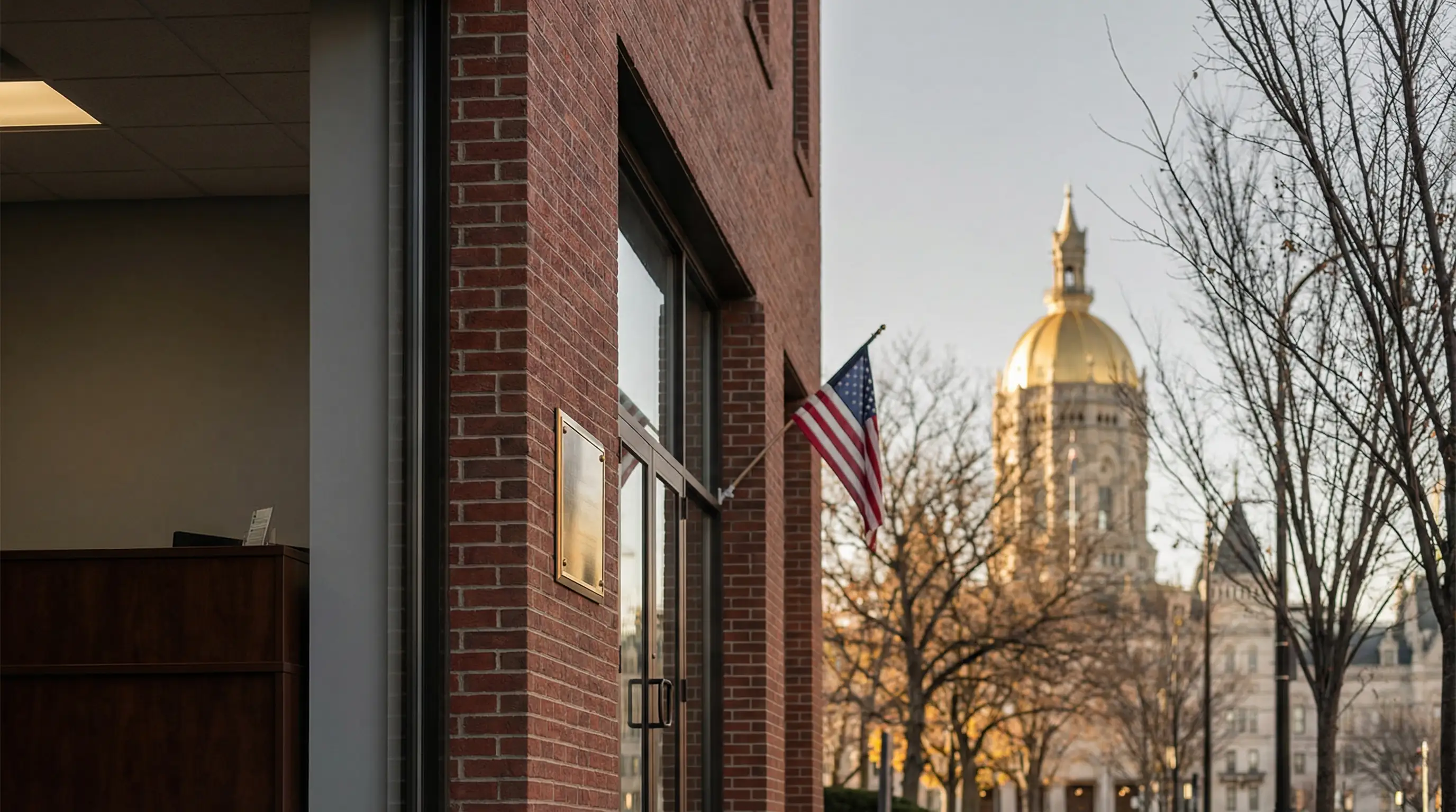 Professional insurance consultation at a Hartford, CT independent agency office with Connecticut State Capitol visible in background