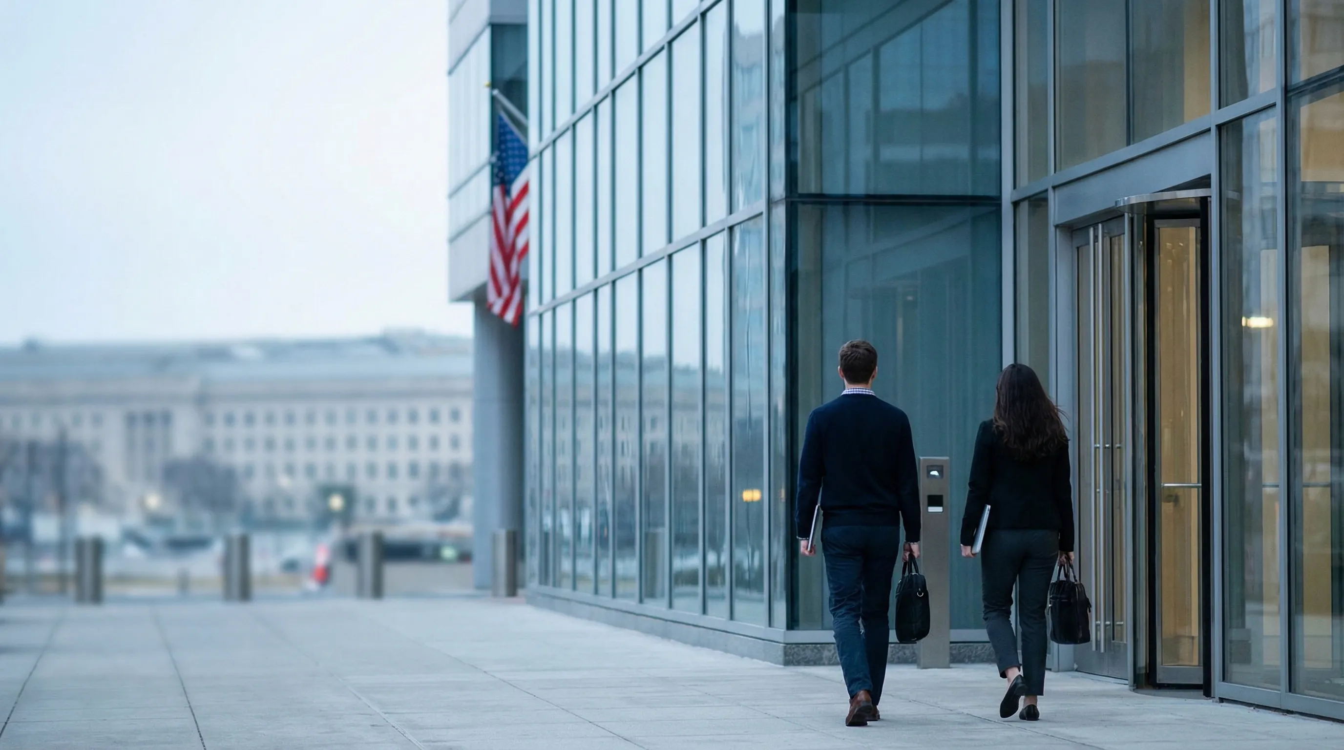 Clean server room and network operations center in an Arlington, VA managed IT firm with a cybersecurity analyst monitoring a dashboard showing CMMC-compliant client network health