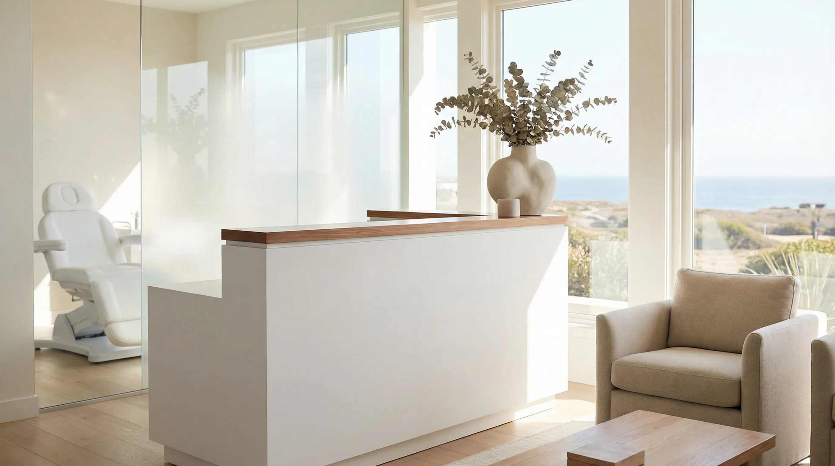 Licensed aesthetics provider in a bright, modern medspa treatment room consulting with a client in Oceanside, CA