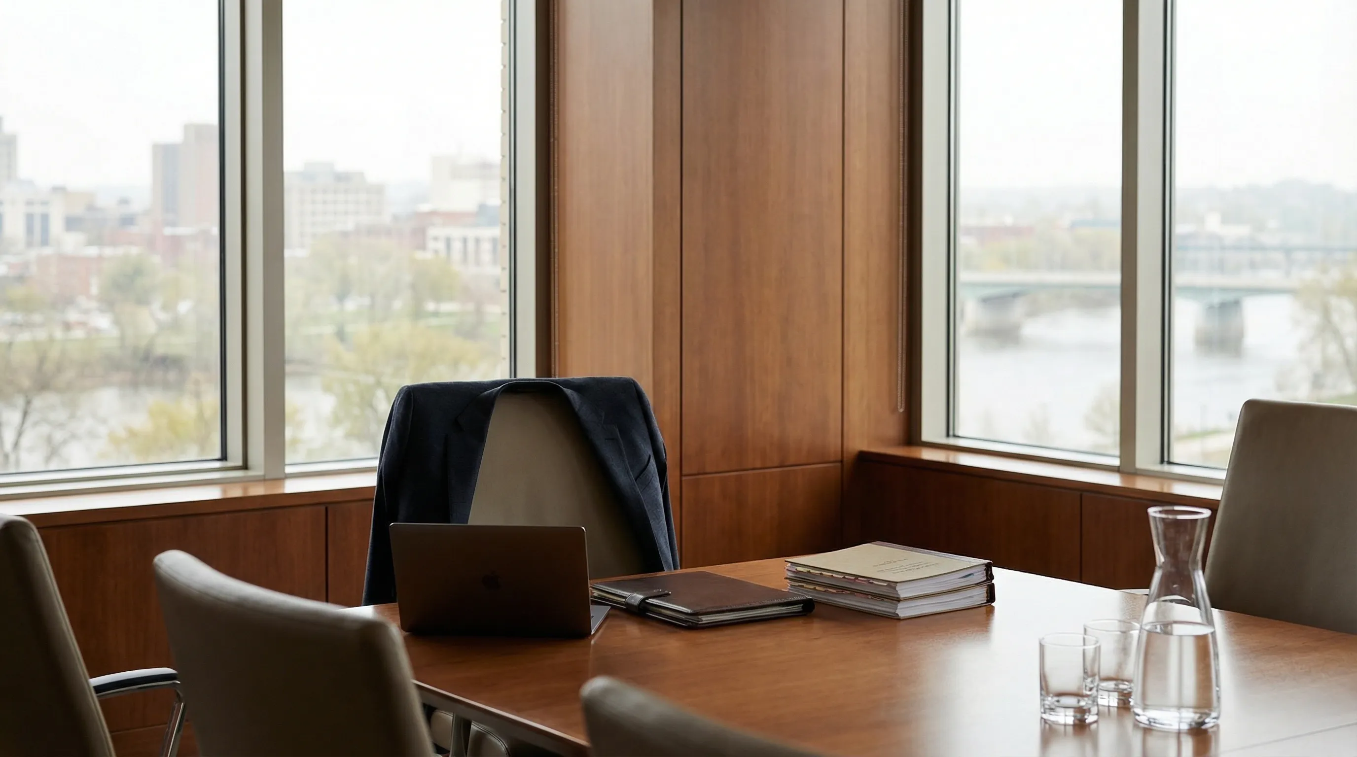 Professional attorney consulting with a client in a modern Cedar Rapids, IA law office conference room with legal documents on the table