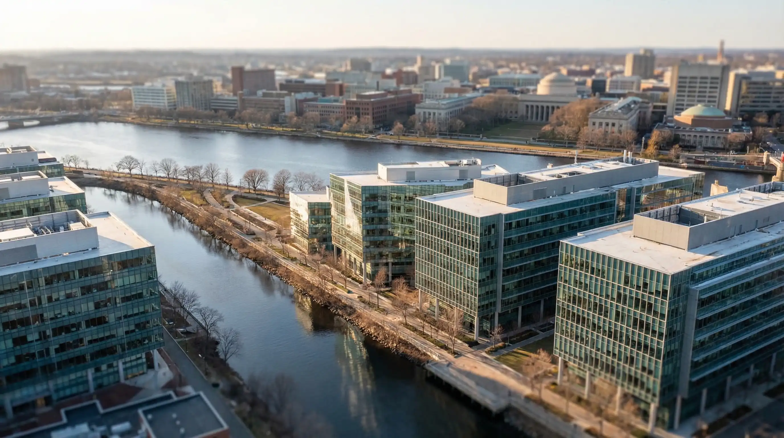 Life sciences researcher in white lab coat working at a modern biotech laboratory bench in Cambridge MA Kendall Square research facility