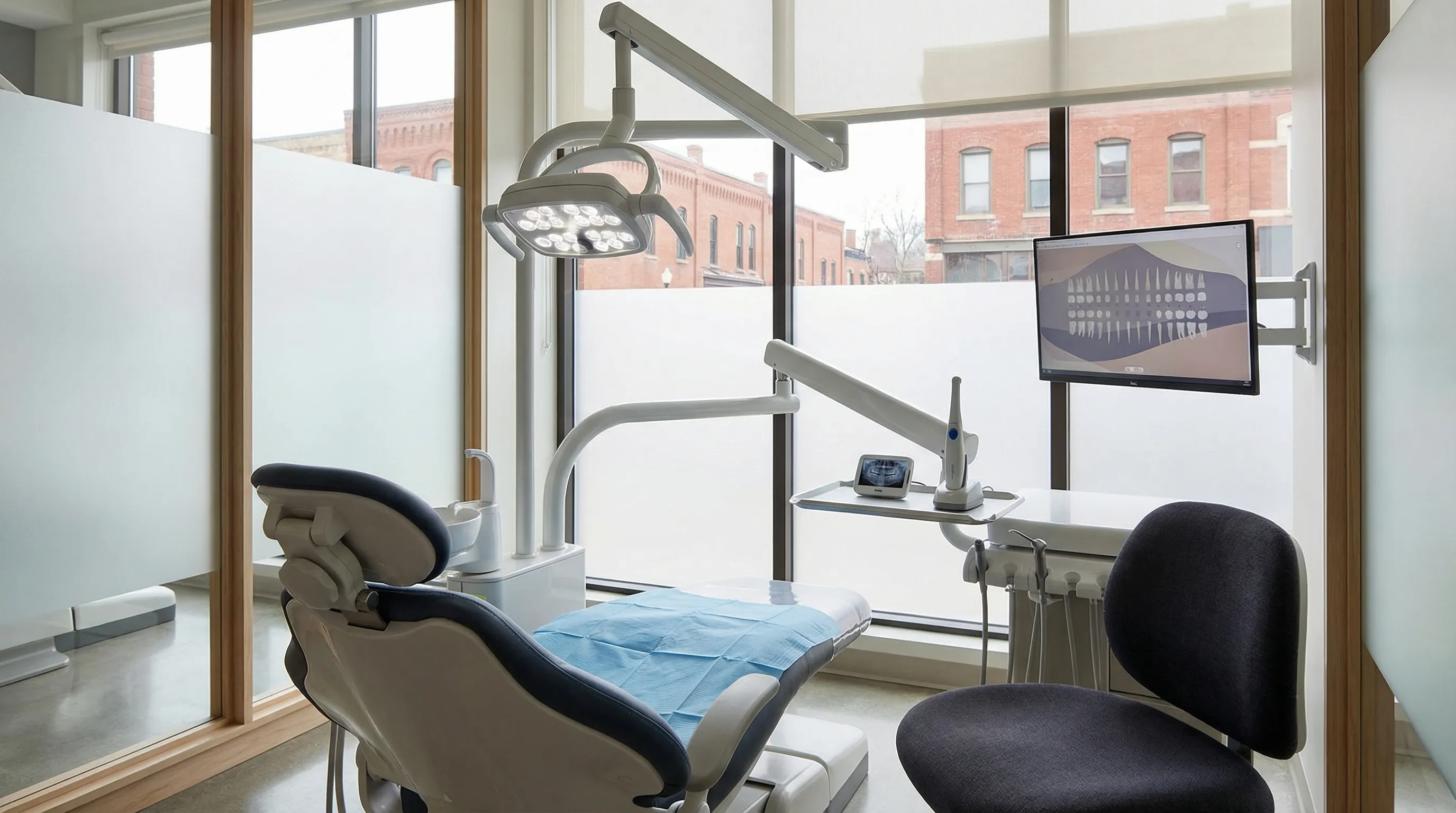 Modern dental exam room interior in a Manchester, NH independent dental practice with LED exam light and digital equipment