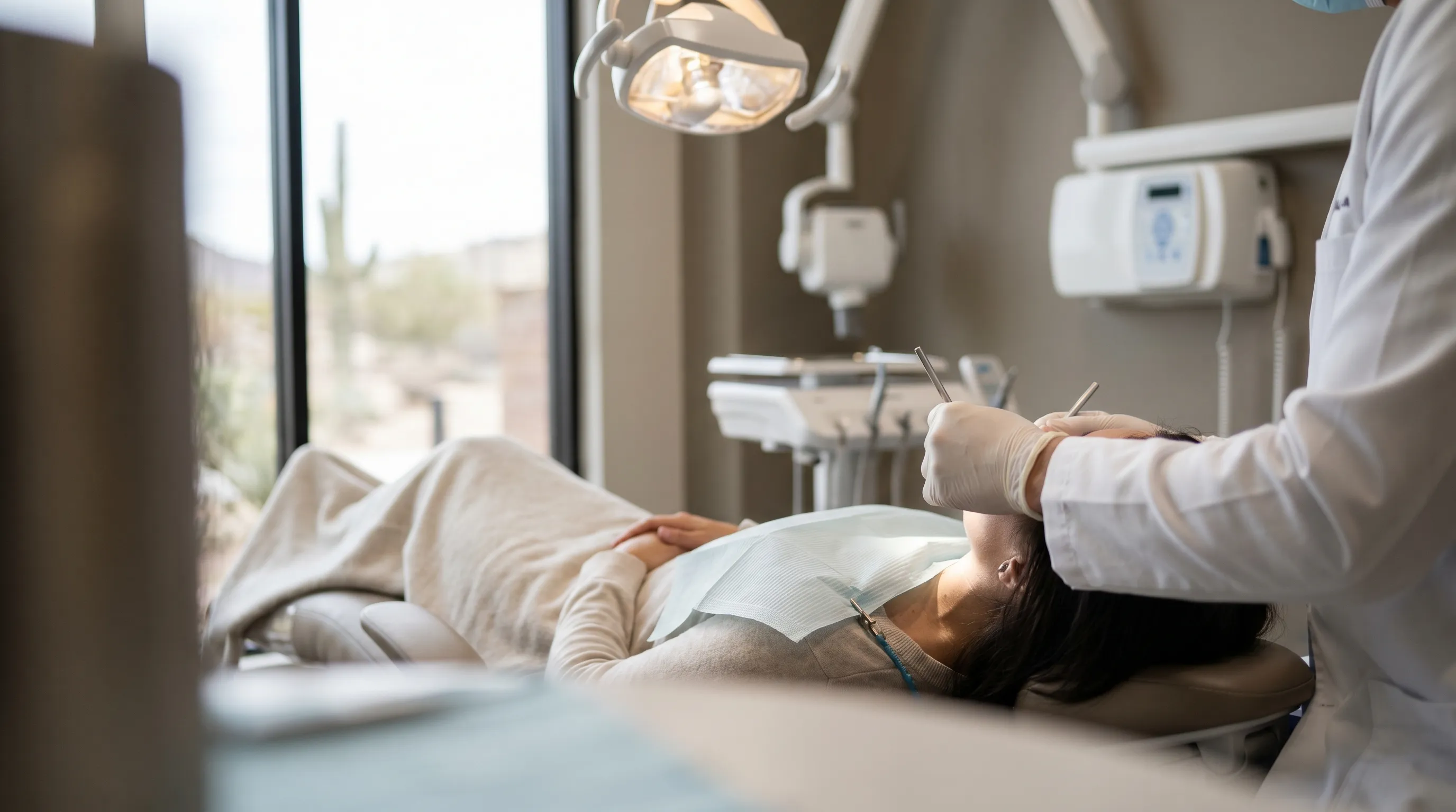 Professional dentist in white coat working with a patient in a modern dental practice in Pueblo, CO