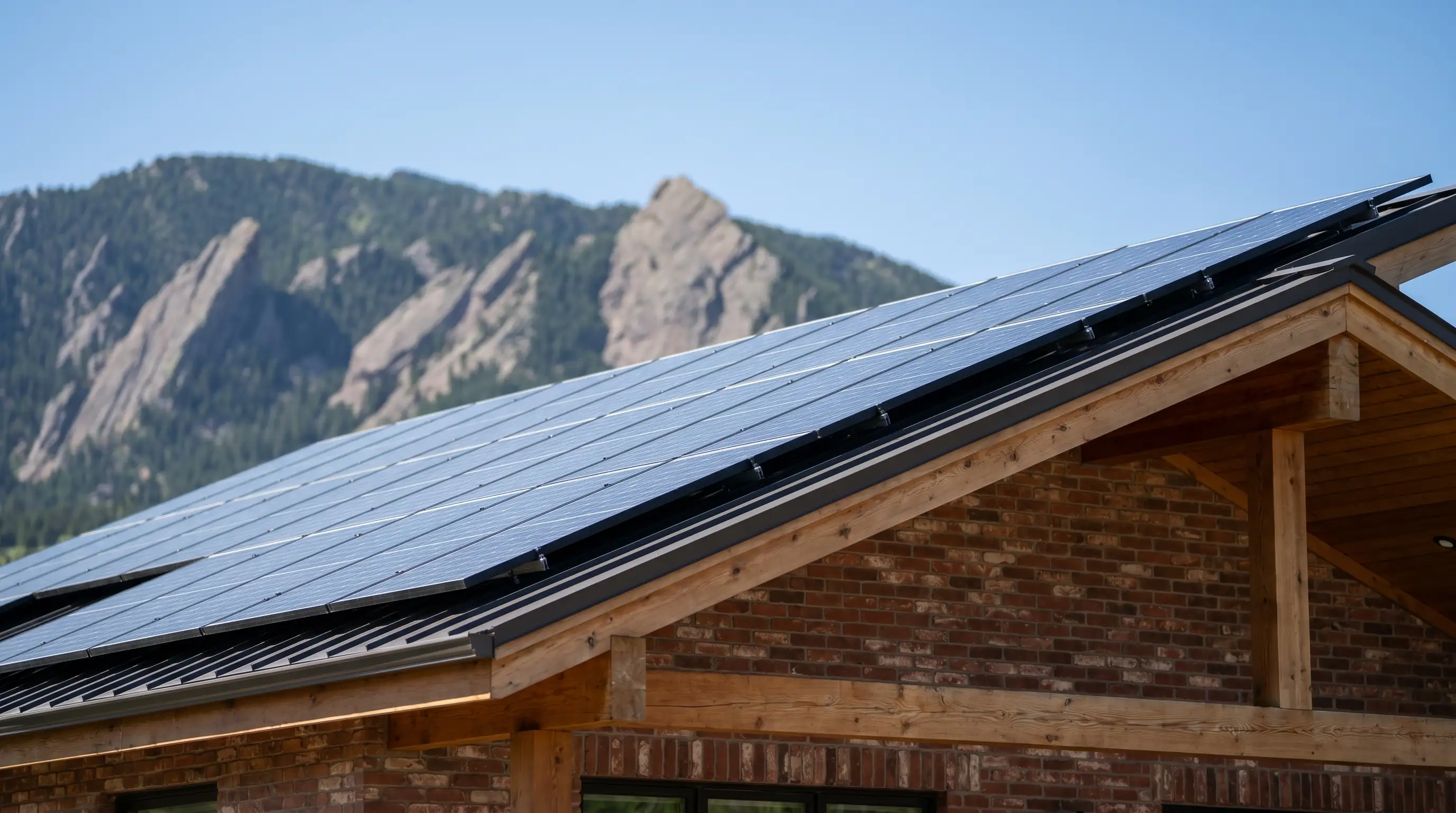 Solar panels on modern Boulder CO home roof with Flatirons rock formations visible in background