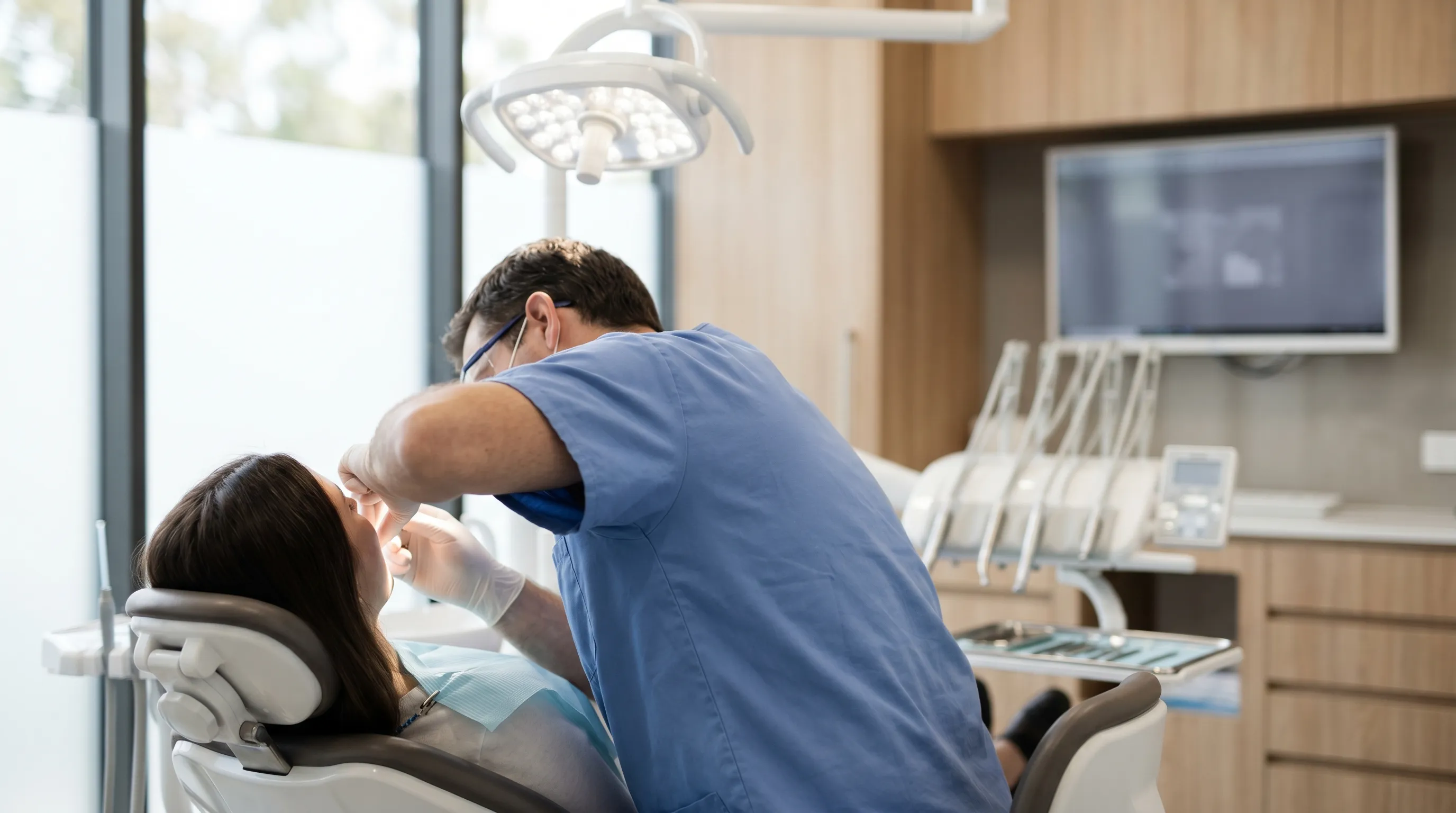 Professional dental practice interior with dentist and patient in treatment room in Danbury, CT
