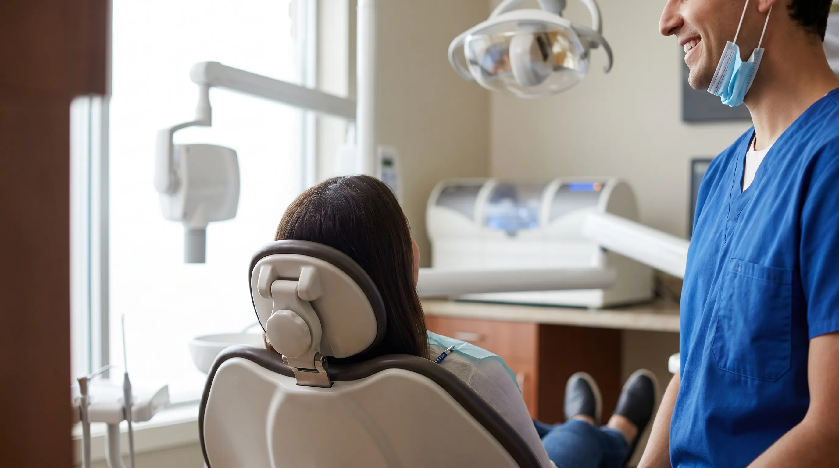 Friendly Cranston dentist consulting with a patient in a modern dental office in Rhode Island