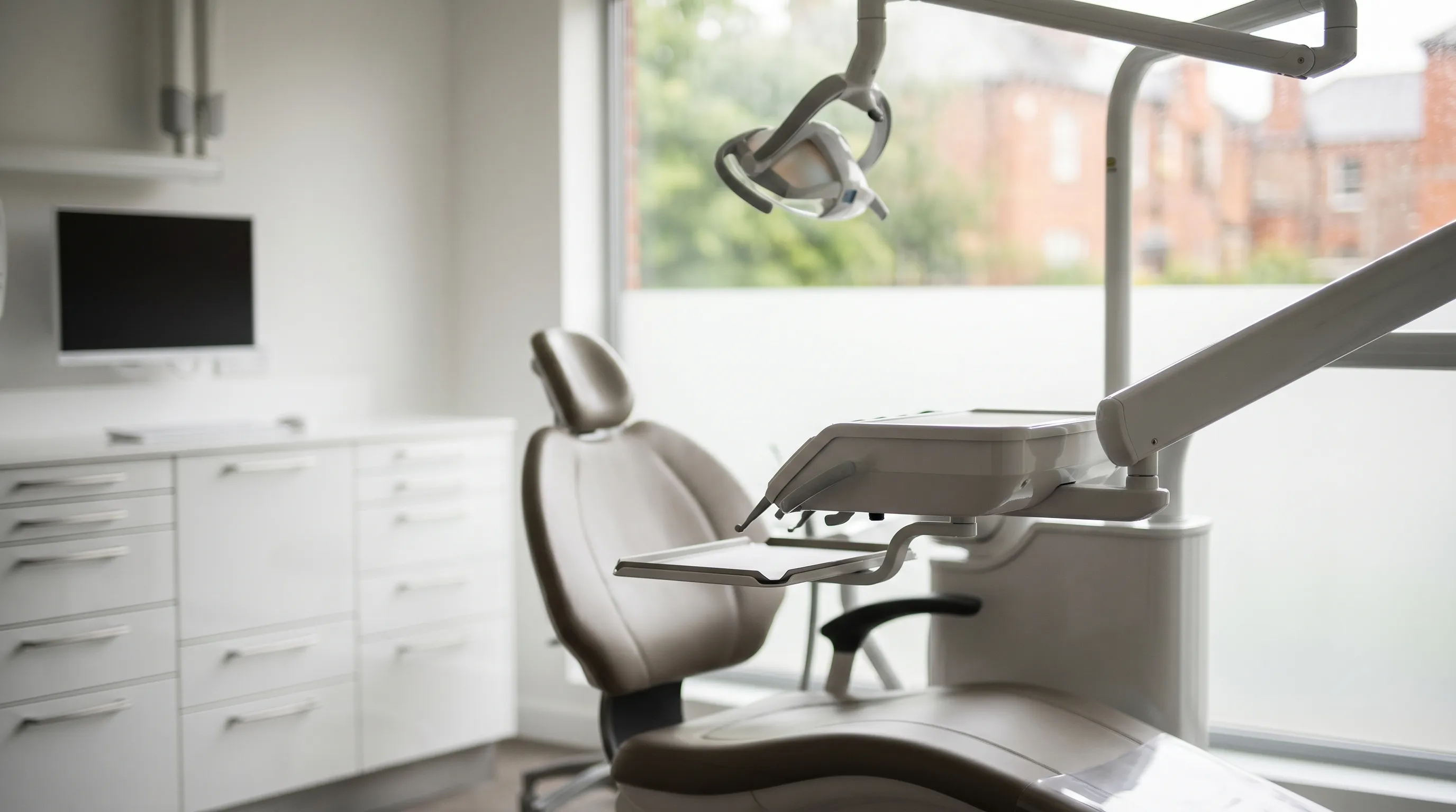 Modern dental treatment room interior in Auburn, AL with dentist examining a patient under professional lighting