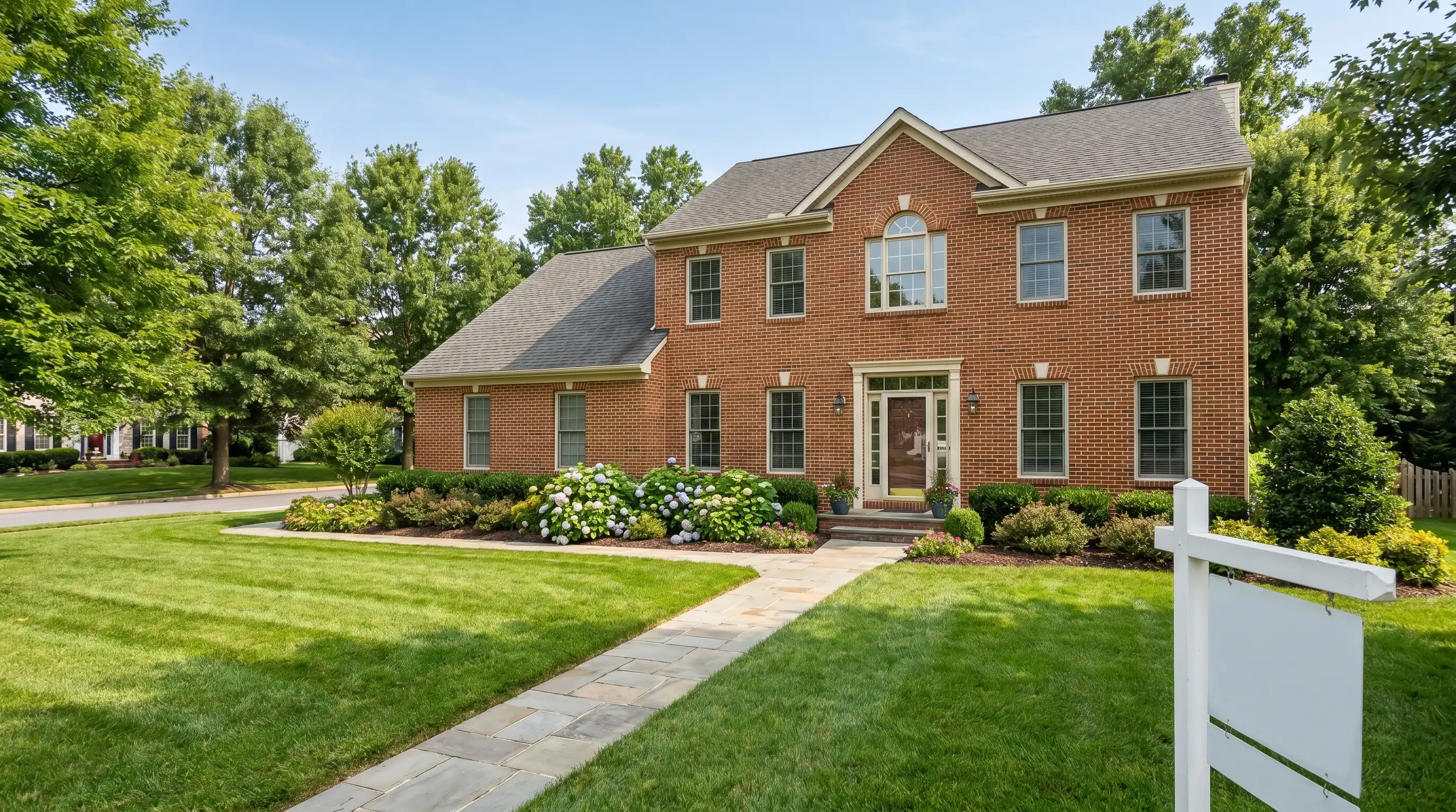Real estate agent showing a beautifully staged colonial home to a professional couple in a sun-filled modern kitchen in Frederick, MD