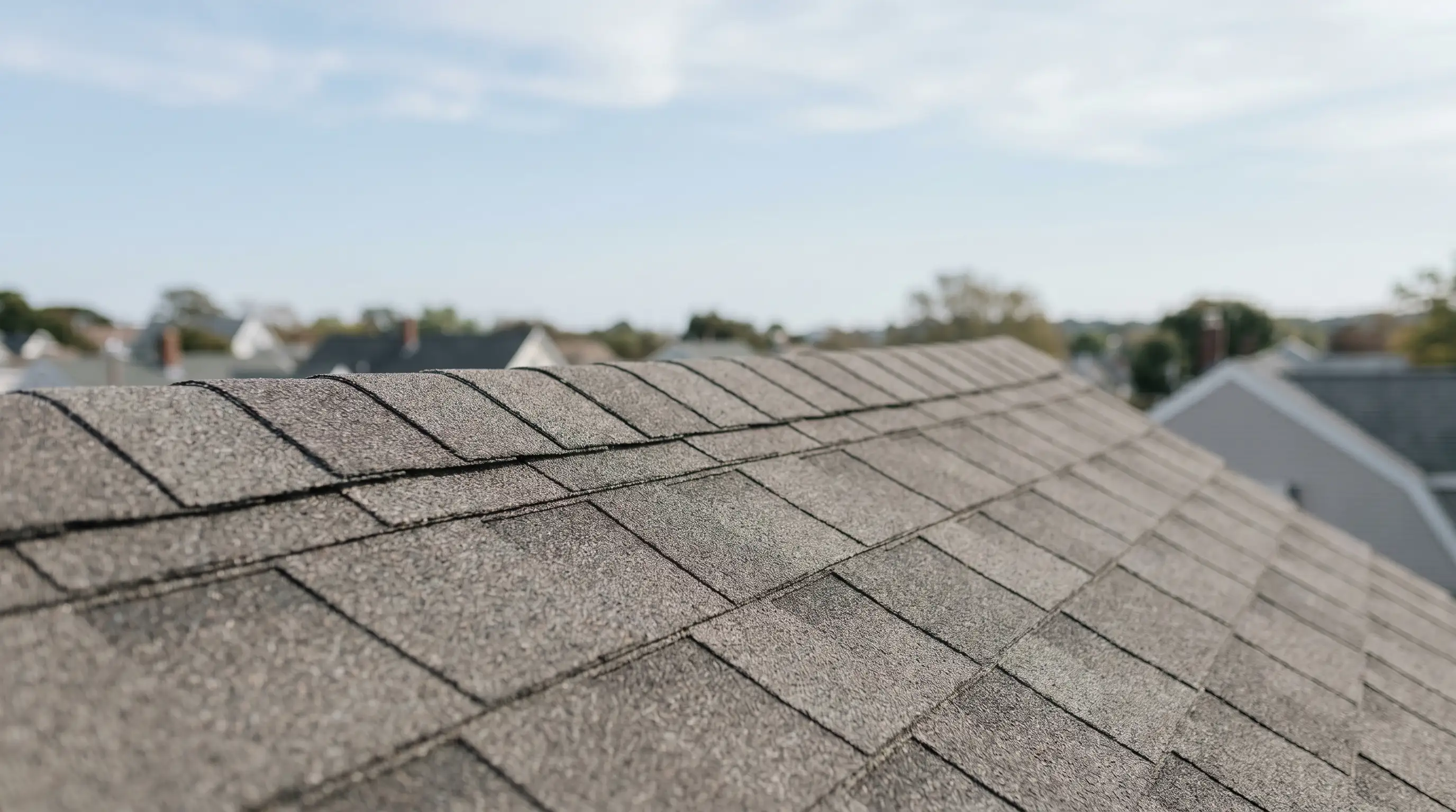 Professional roofers installing new asphalt shingles on a historic Pawtucket, RI home