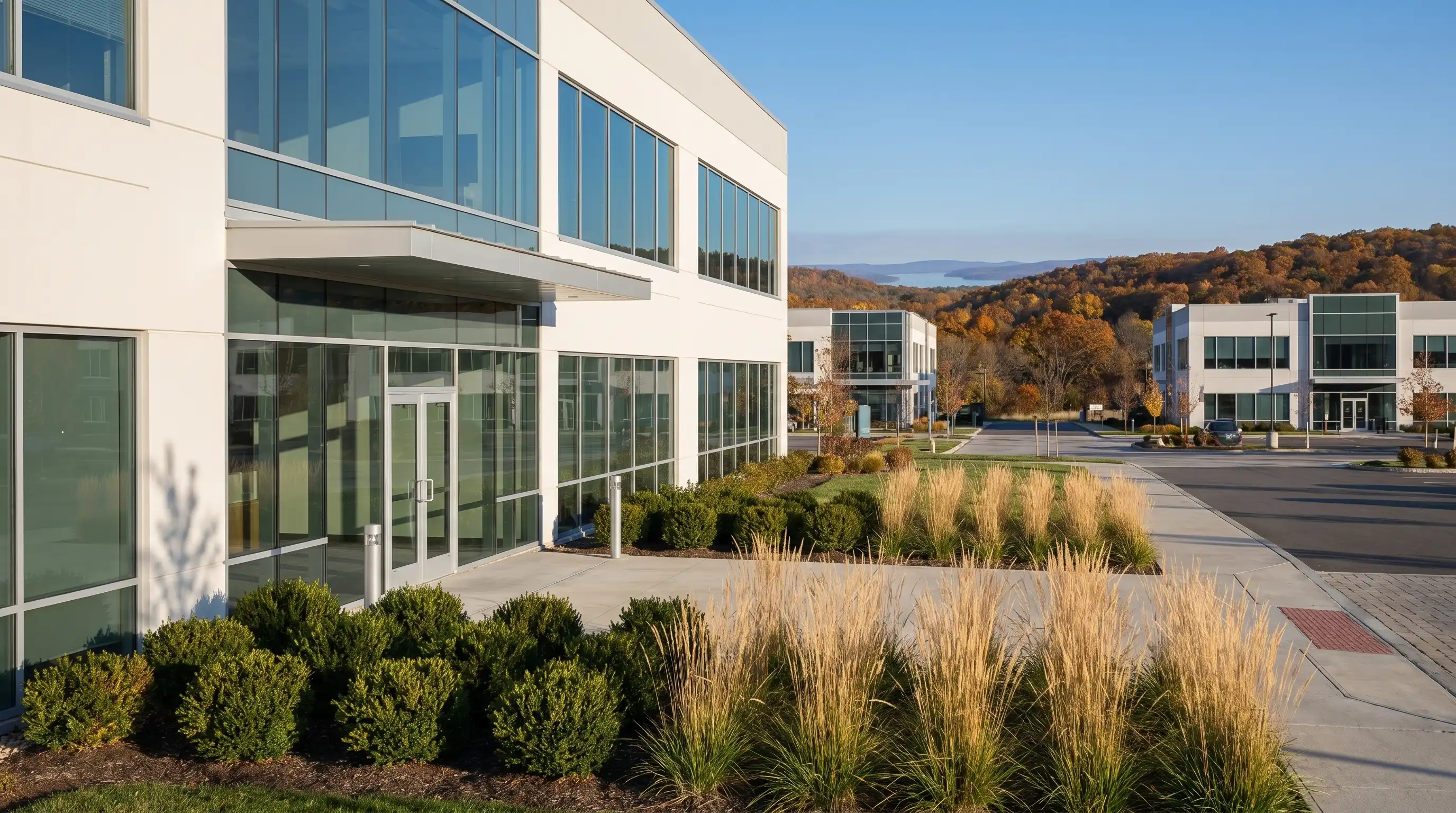 Modern dental office exterior in a professional medical plaza in Rogers, AR with clean white facade and welcoming front entrance under a clear blue sky