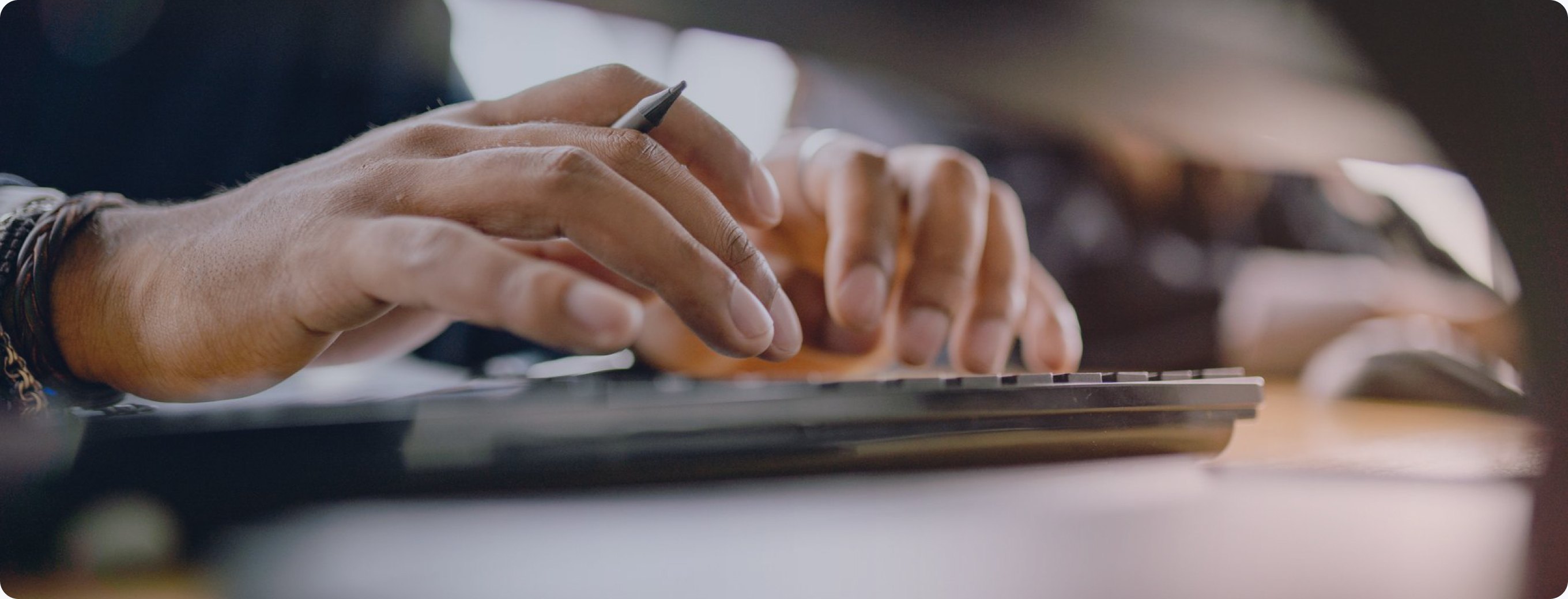 Close-up of hands typing on a keyboard