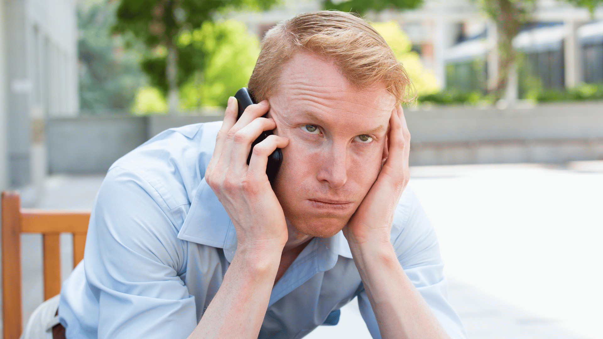 irritated person on phone waiting for someone to answer