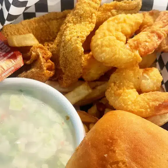 A basket of fried food with a bowl of soup.
