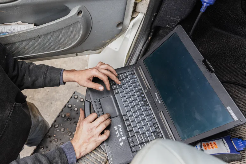 Engine diagnostics being run on a semi-truck using a Panasonic Toughbook and USB-Link 2 adapter.