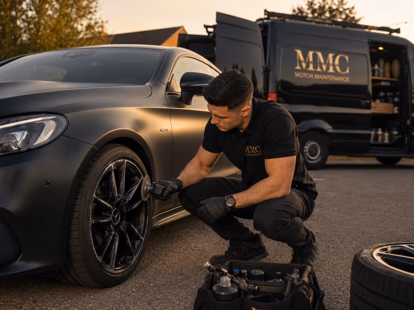 Mobile alloy wheel repair and refurbishment on a black Mercedes by Motor Market Connect