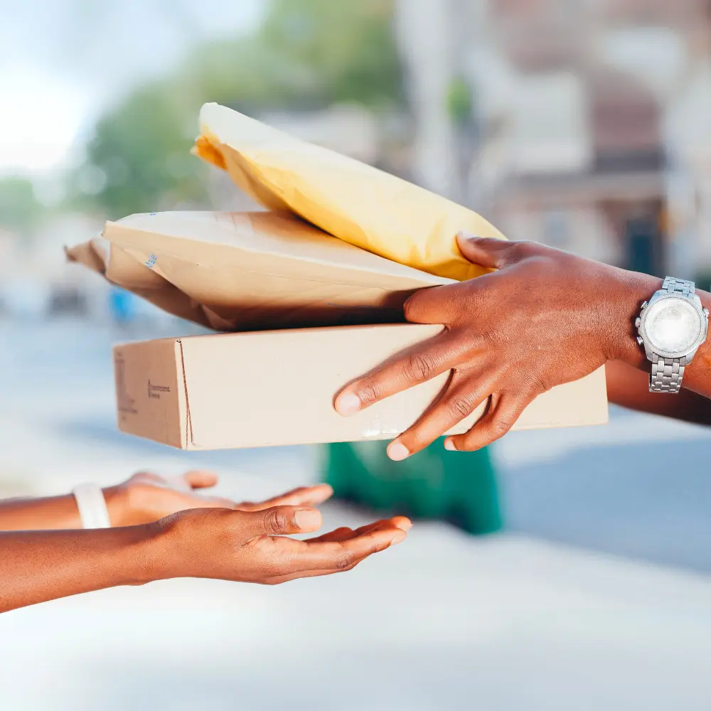 Photo of one person handing a package to another