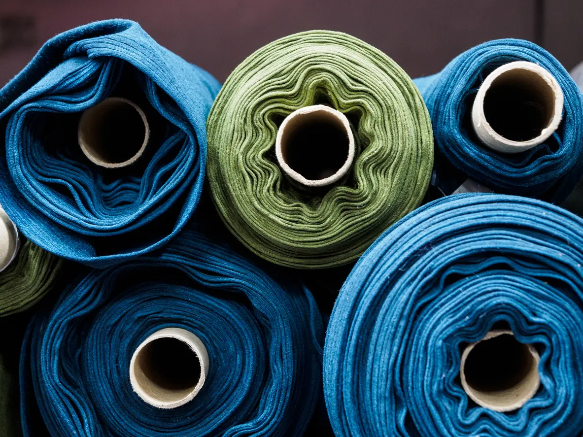 Textiles rolled up and stacked on each other