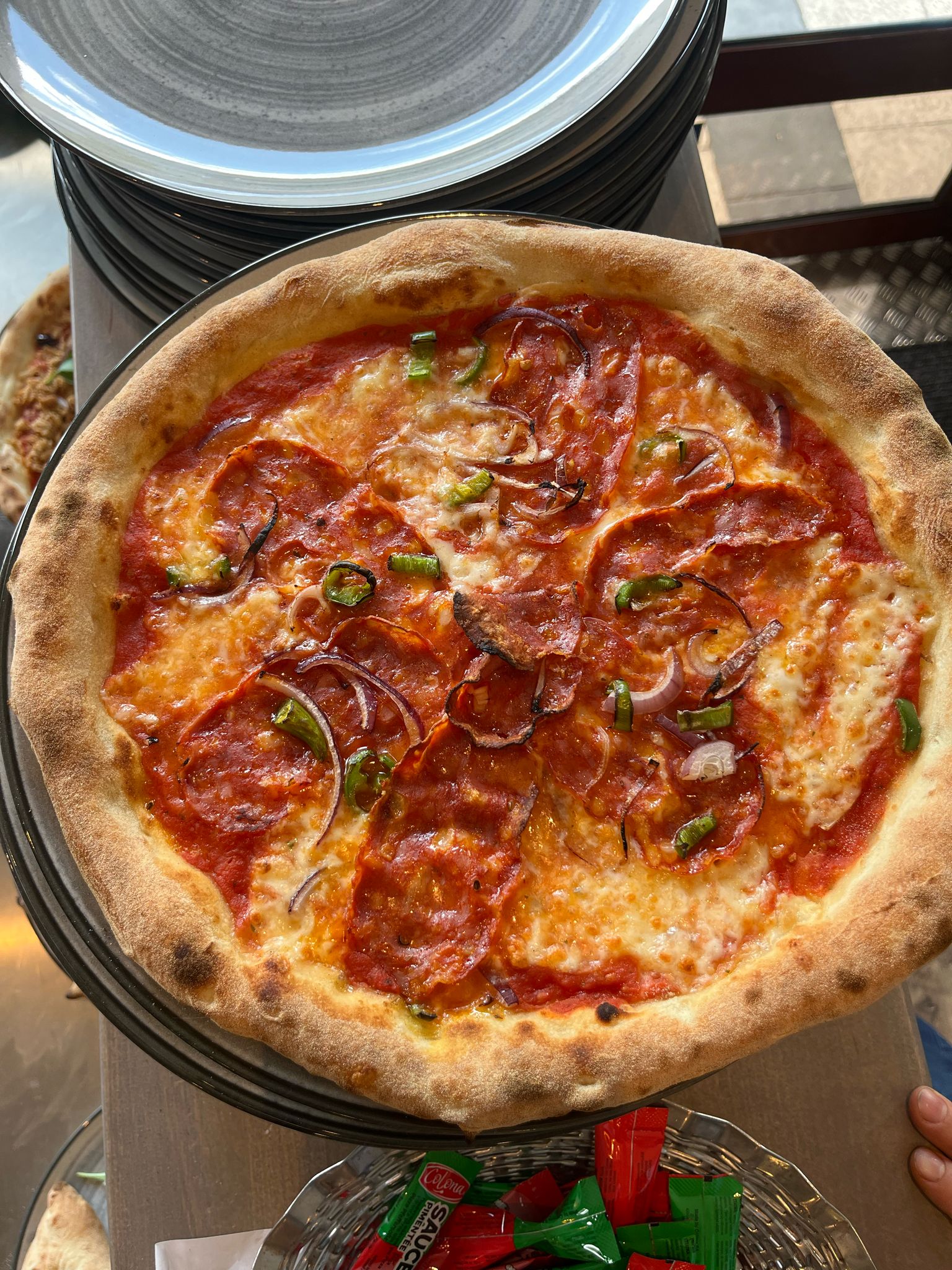 Two guys busy in the kitchen preparing pizza