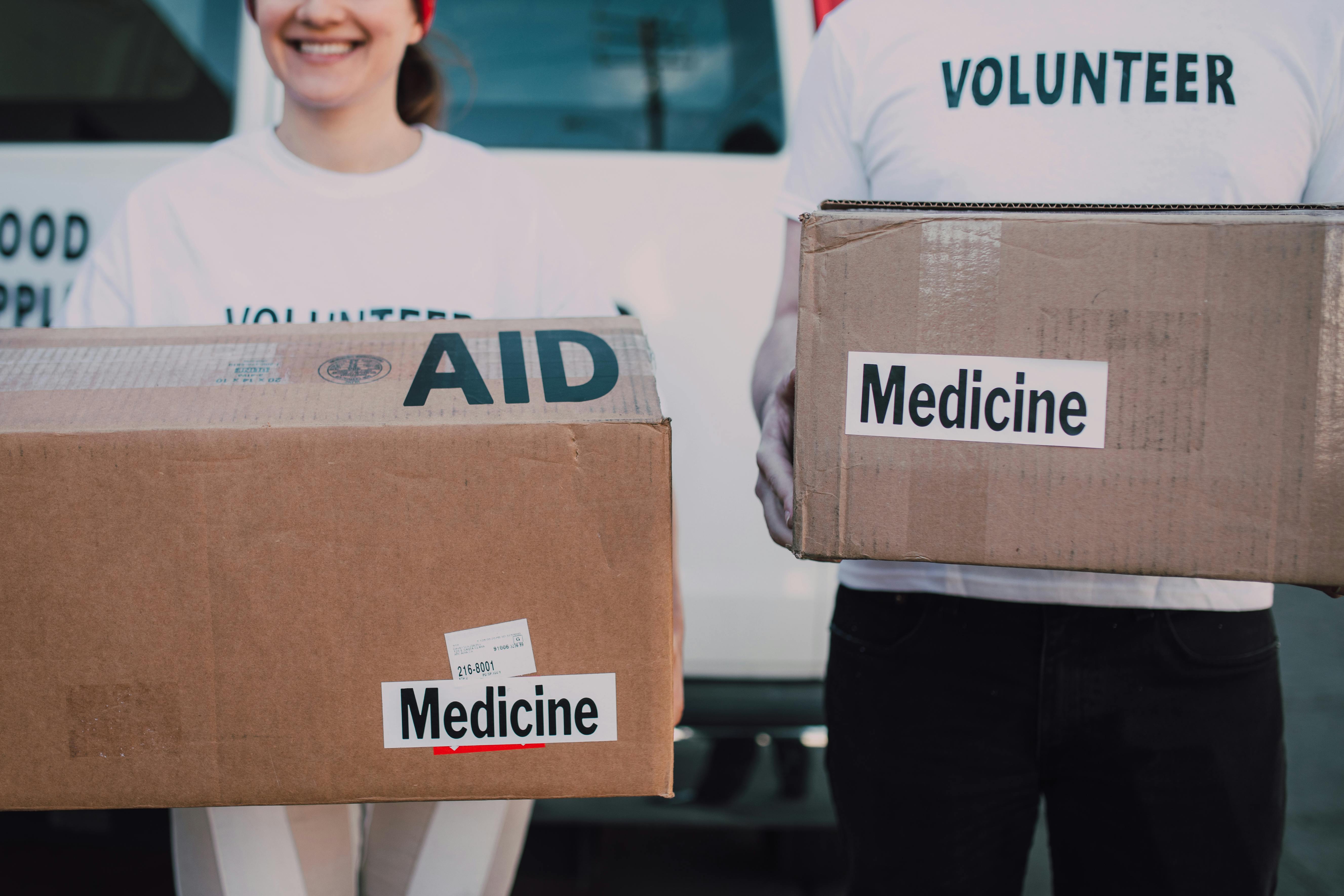 Volunteers carrying medicine