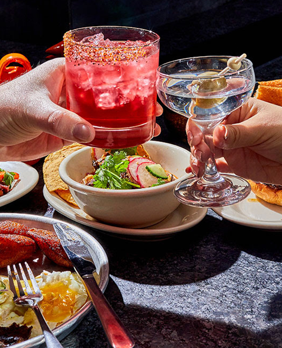 Grilled chorizo burger with melted cheese, seasoned meat, and shredded lettuce on a toasted bun with a knife inserted on top.