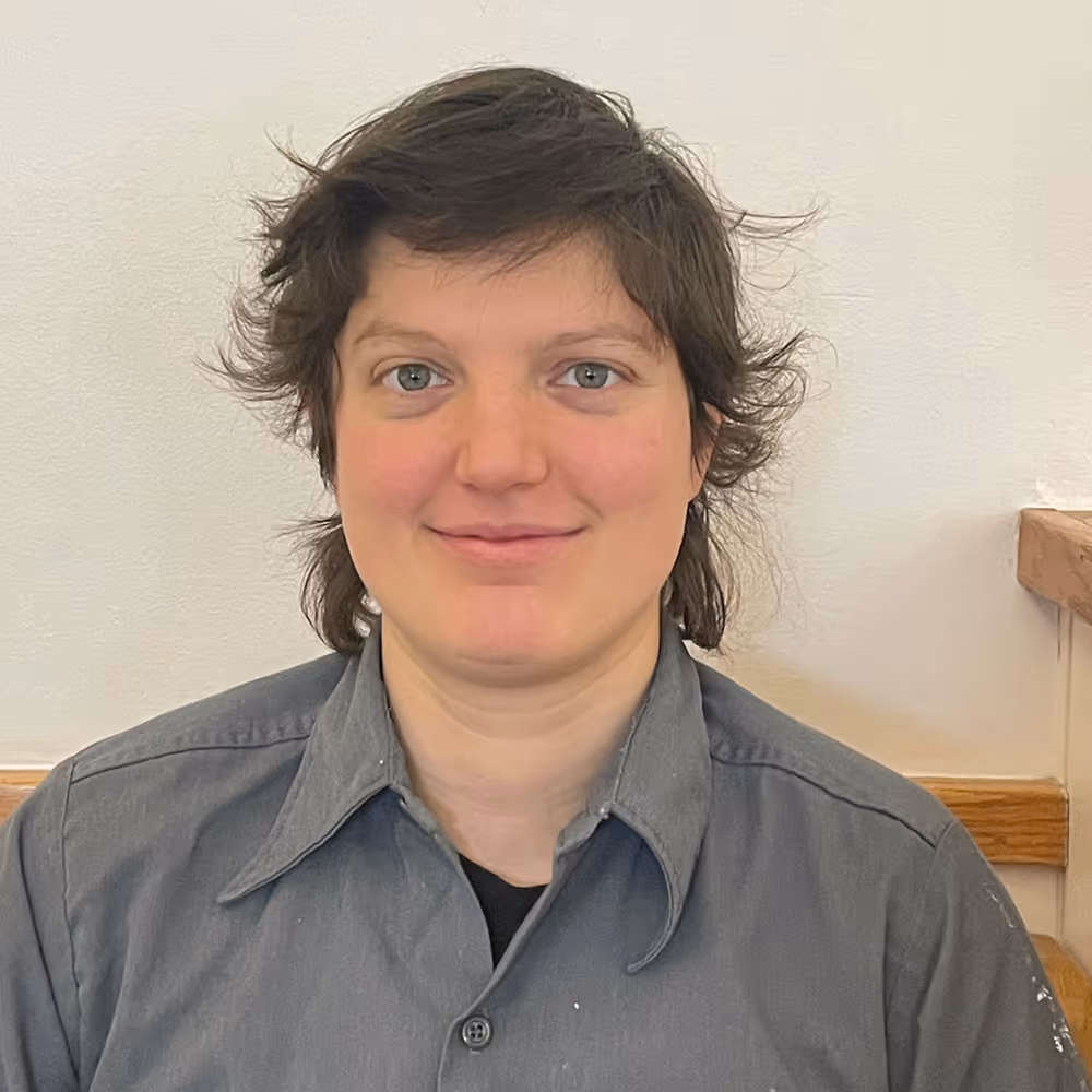 Portrait of a person, facing the camera and slightly smiling.