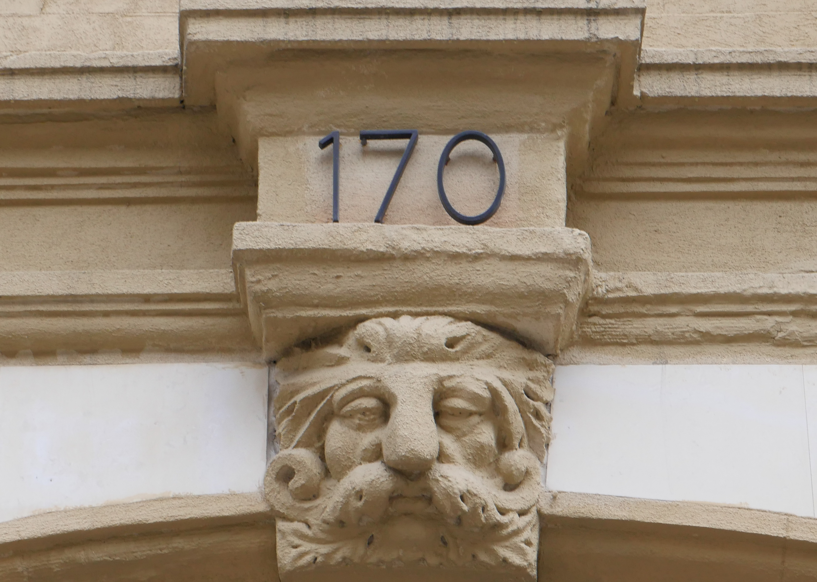 Manhattan Piano Academy building entrance at 170 with historic stone architecture and carved face detail