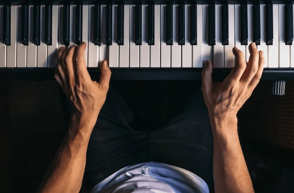 Adult piano student learning in Manhattan studio with professional instructor