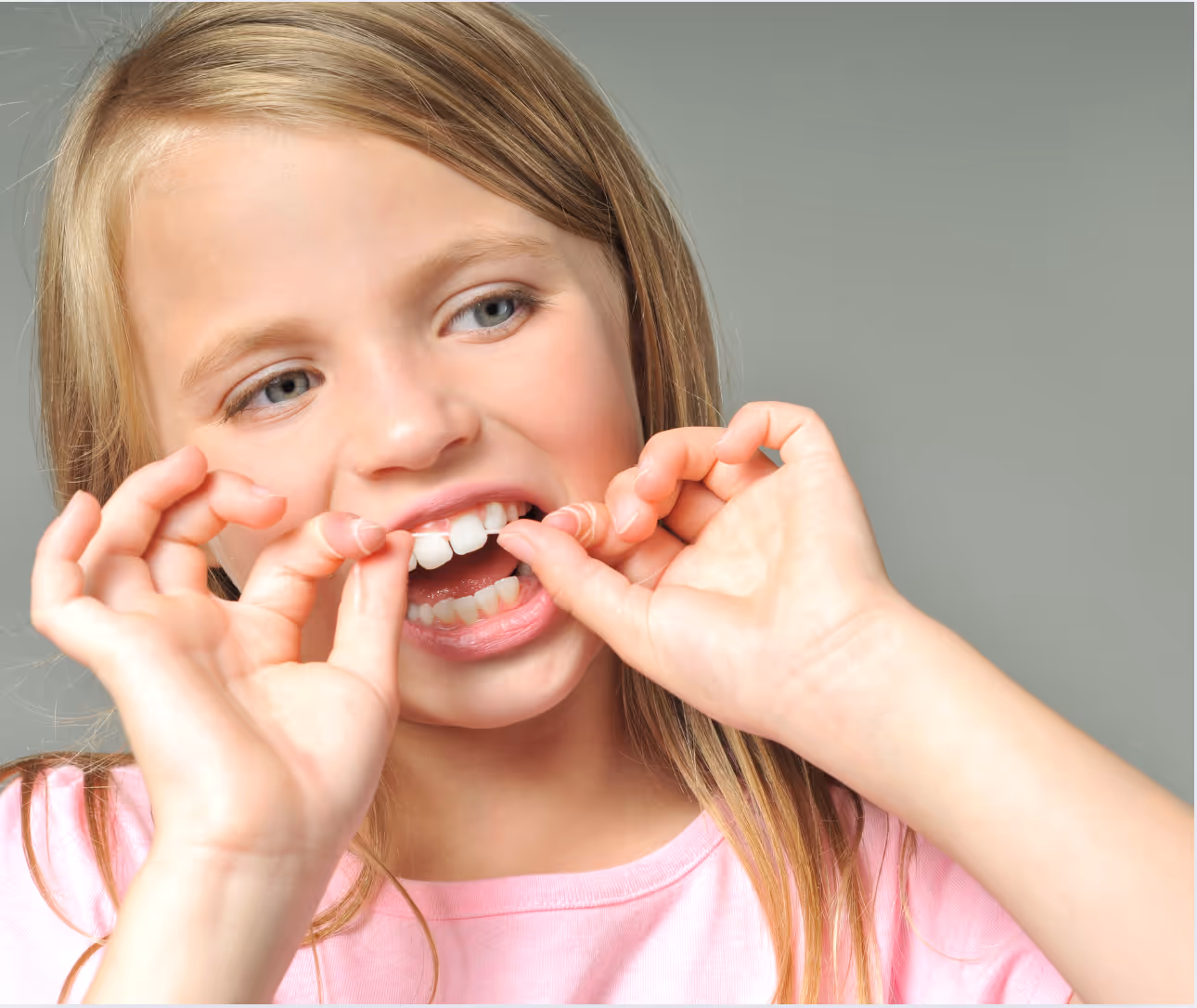 Girl flossing teeth