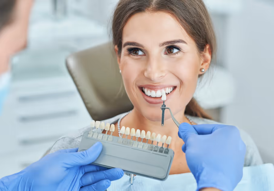 Dentist examining whiteness of patients teeth