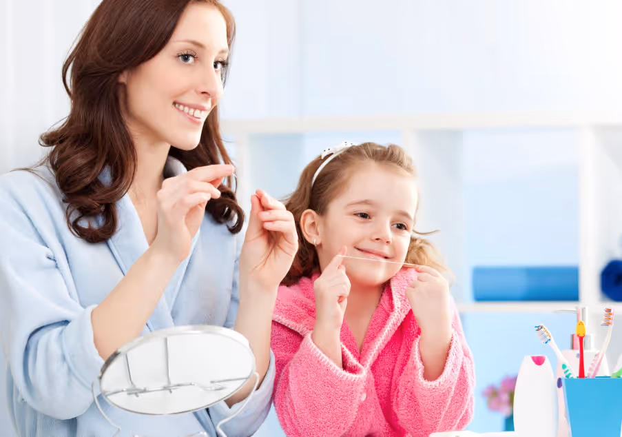Mom and daughter about to floss