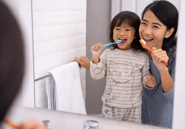 Mom and daughter brushing teeth