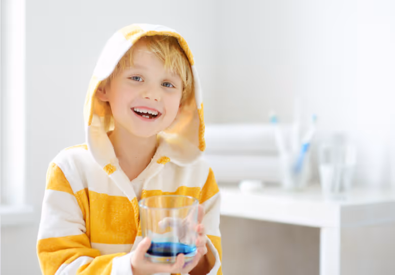 Young boy holding mouthwash