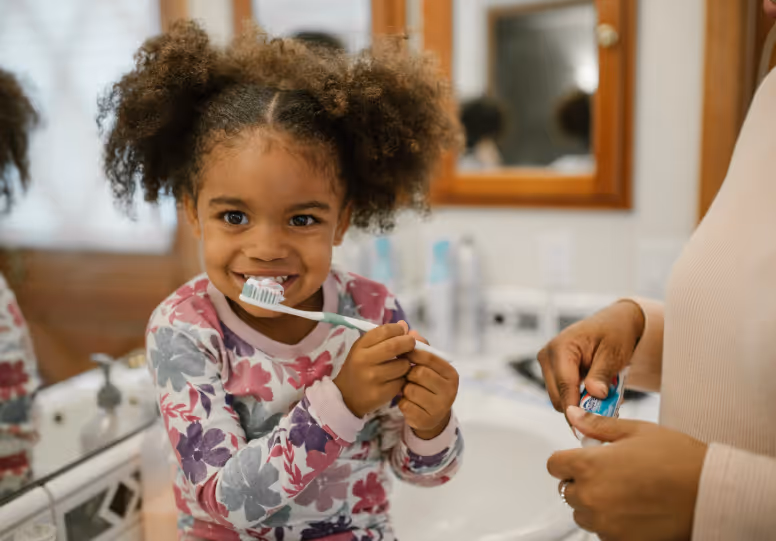 Child brushing her teeth