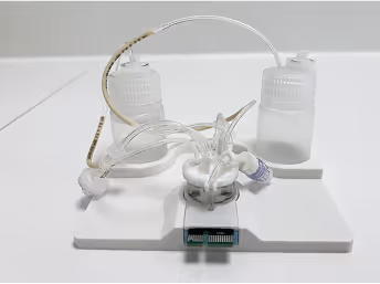 Medical device with tubes and containers on white background