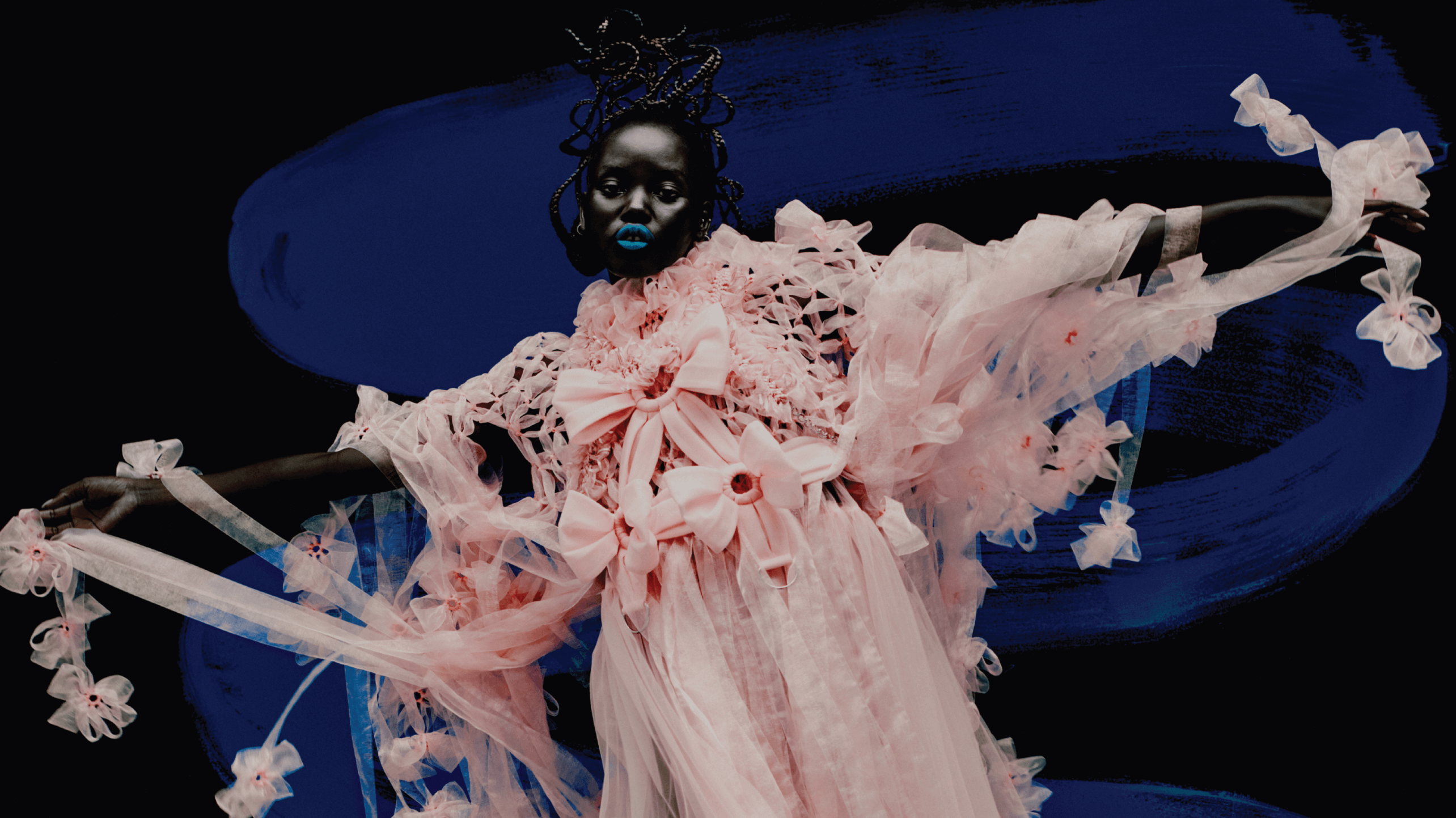 Model in a dramatic, futuristic white outfit against a dark background at Vogue x Snapchat project