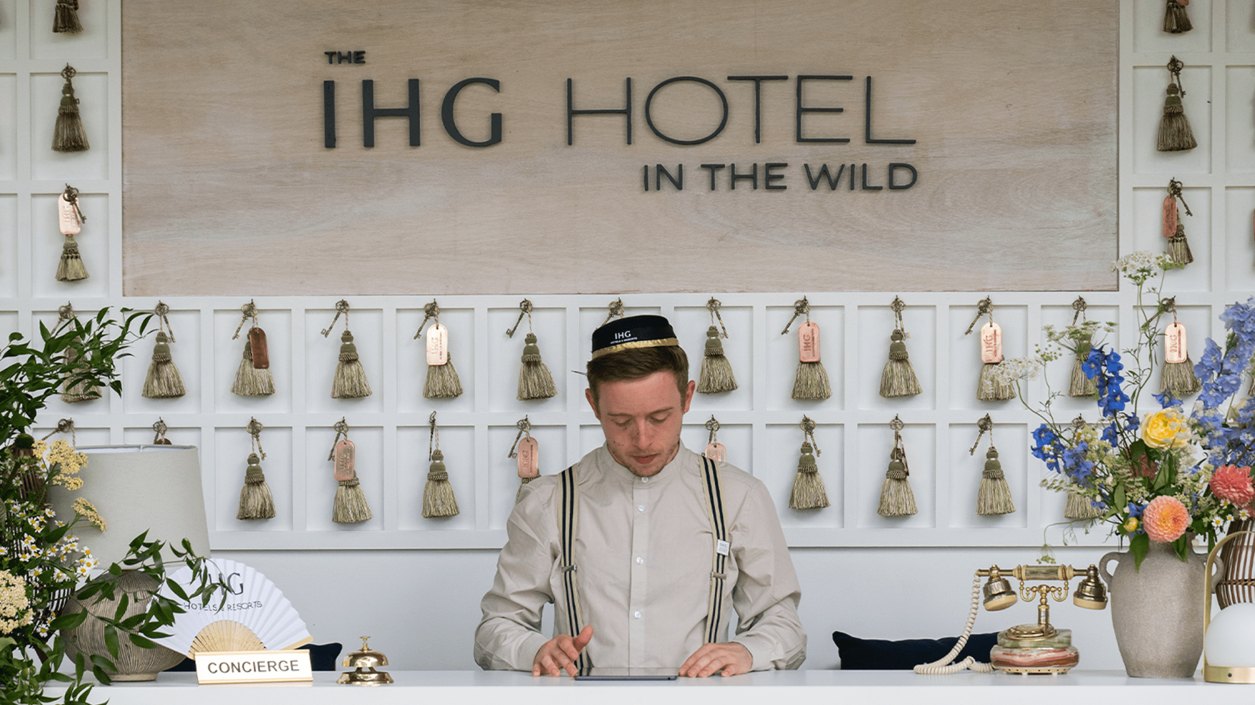 Man smiling behind a flower-filled bar at IHG Hotel for Bloomin' Lovely project