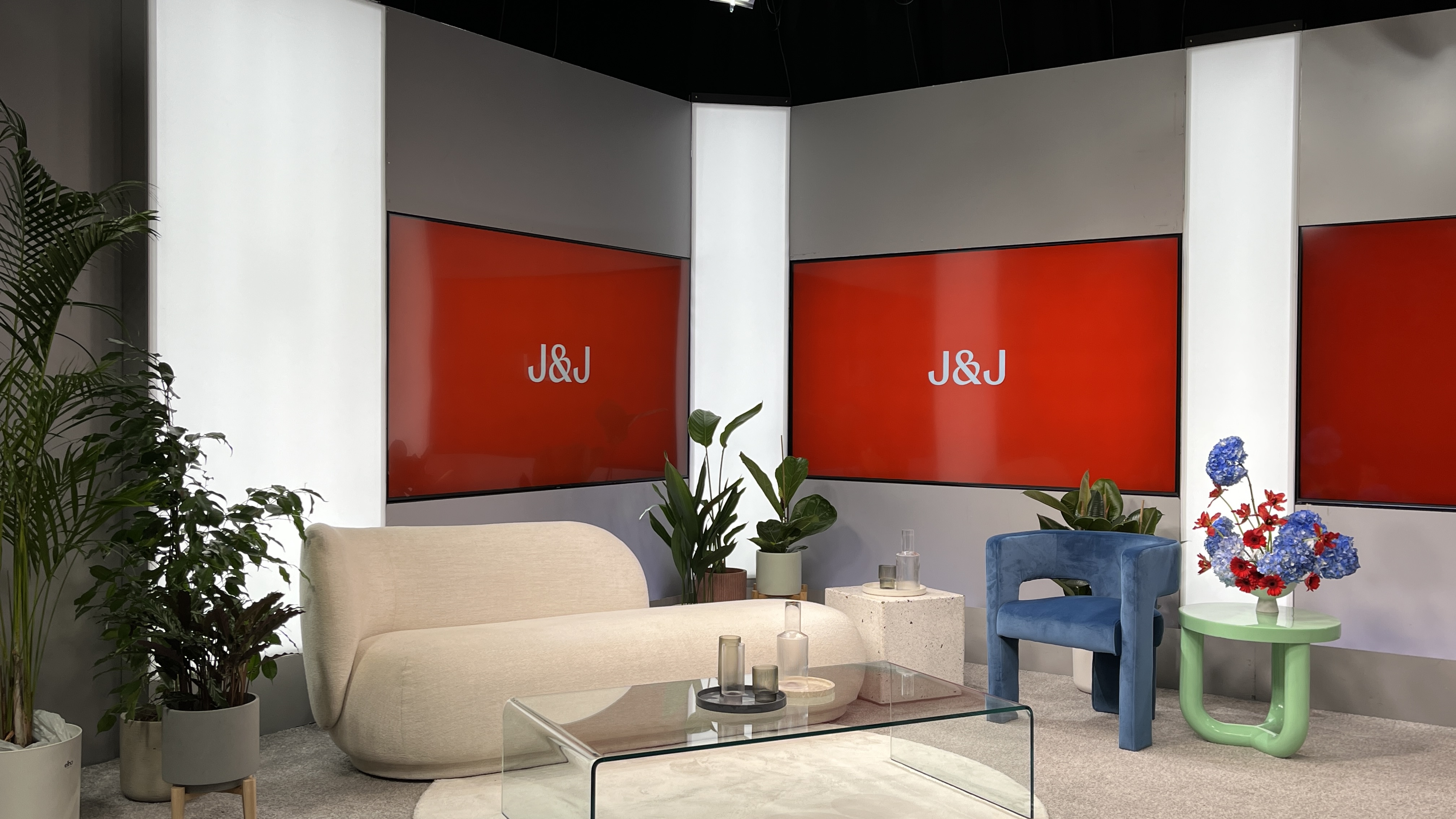 Modern seating area with plants and red accent walls at the rESOolutions event