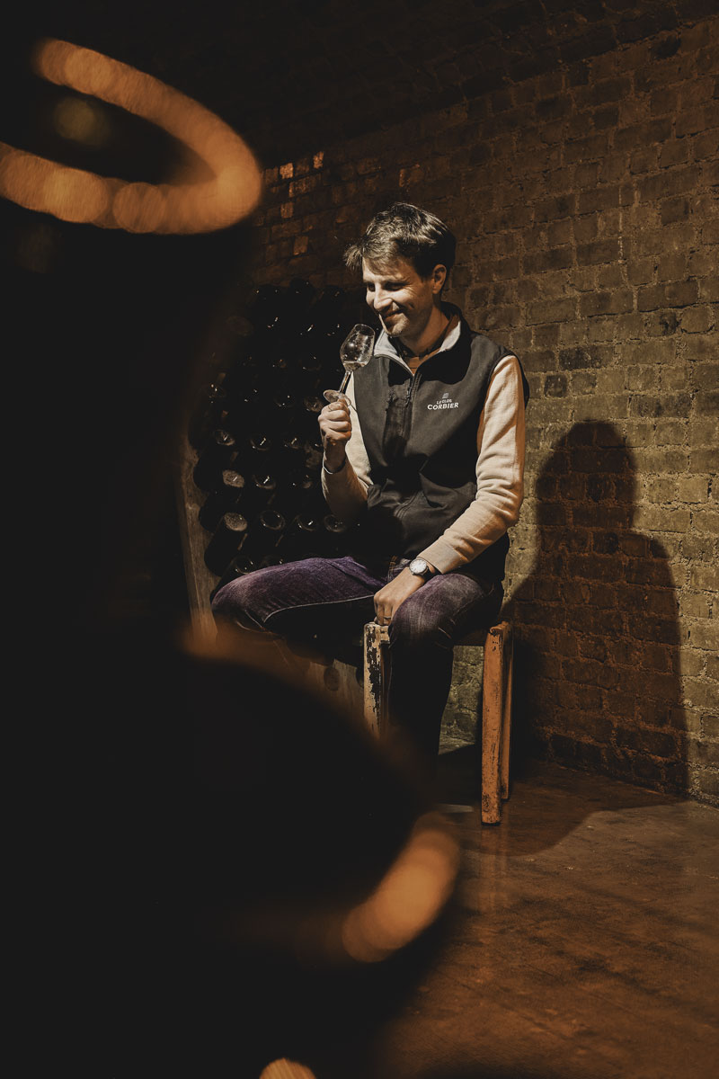 Matthias Collard dans les caves avec un verre de Champagne